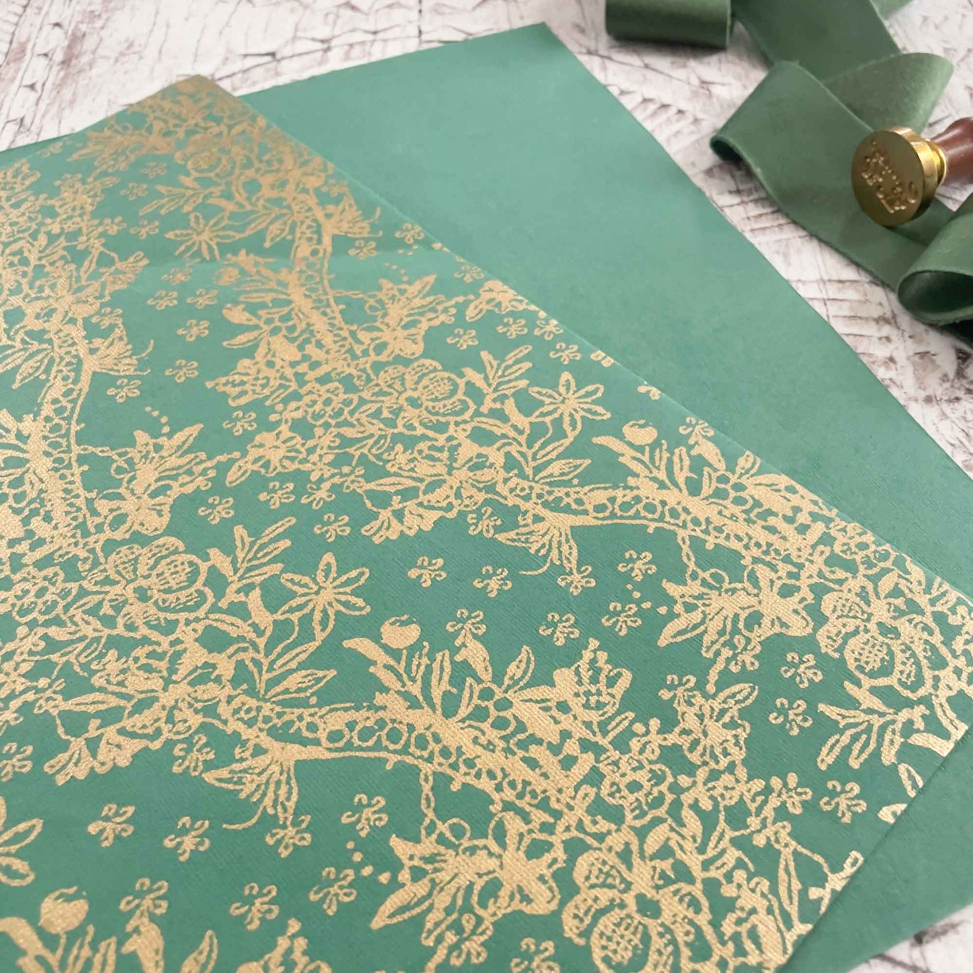 Patterned recycled cotton rag paper in green and gold