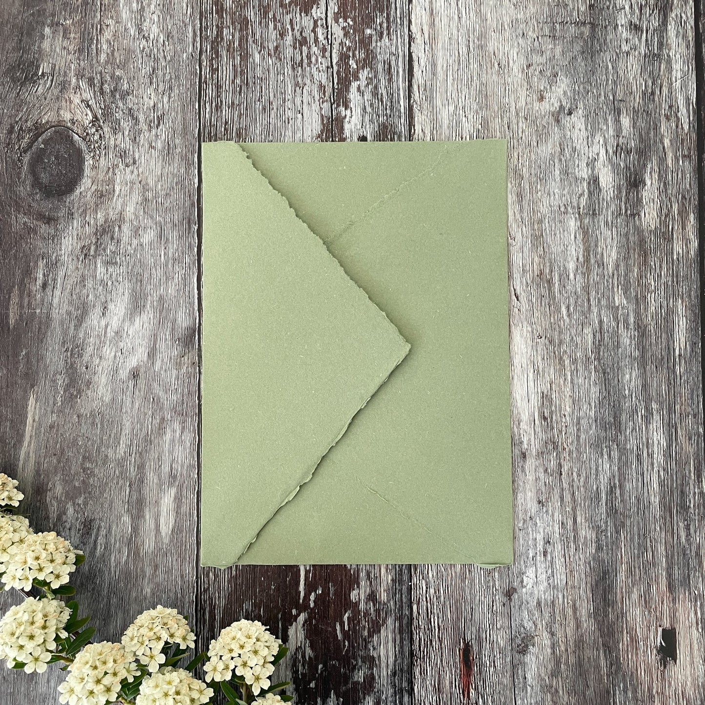 Handmade paper invitation envelope with a deckled edge.  Made from recycled cotton rag fibres.  Sage green hand made envelopes.  By The Natural Paper Company