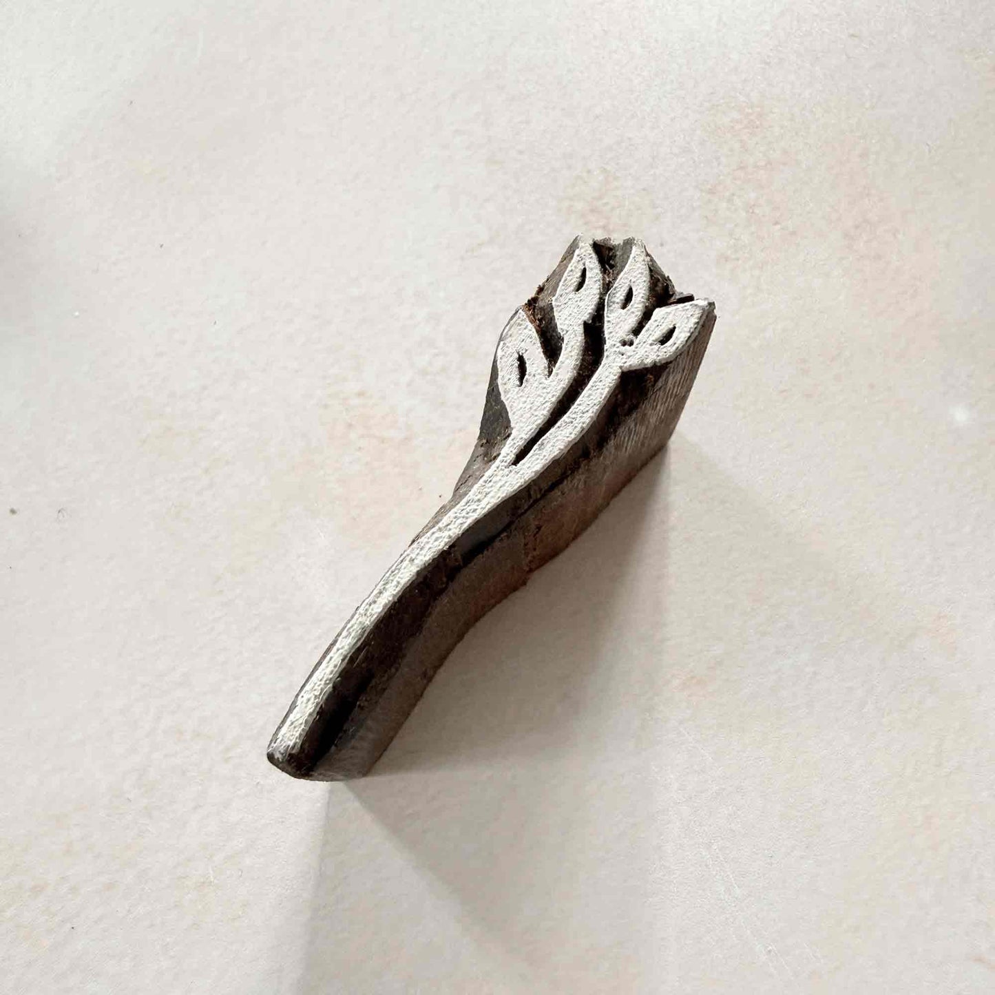 Dulse Indian Wood Block Stamp with a slender curved stem and four delicately carved pointed leaves.