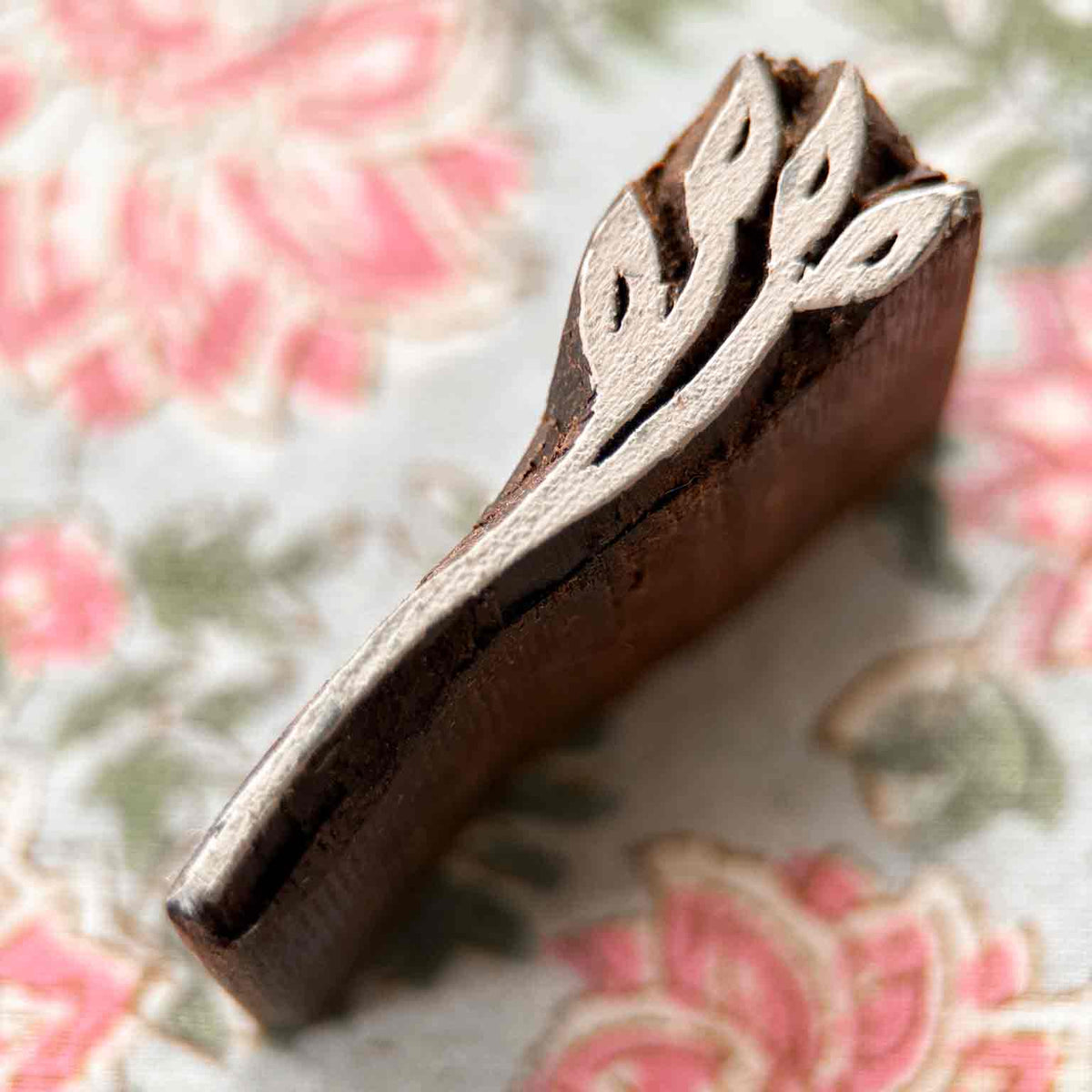 Close-up Dulse Wooden Stamp showing a hand-carved botanical sprig design for fabric and paper block printing.