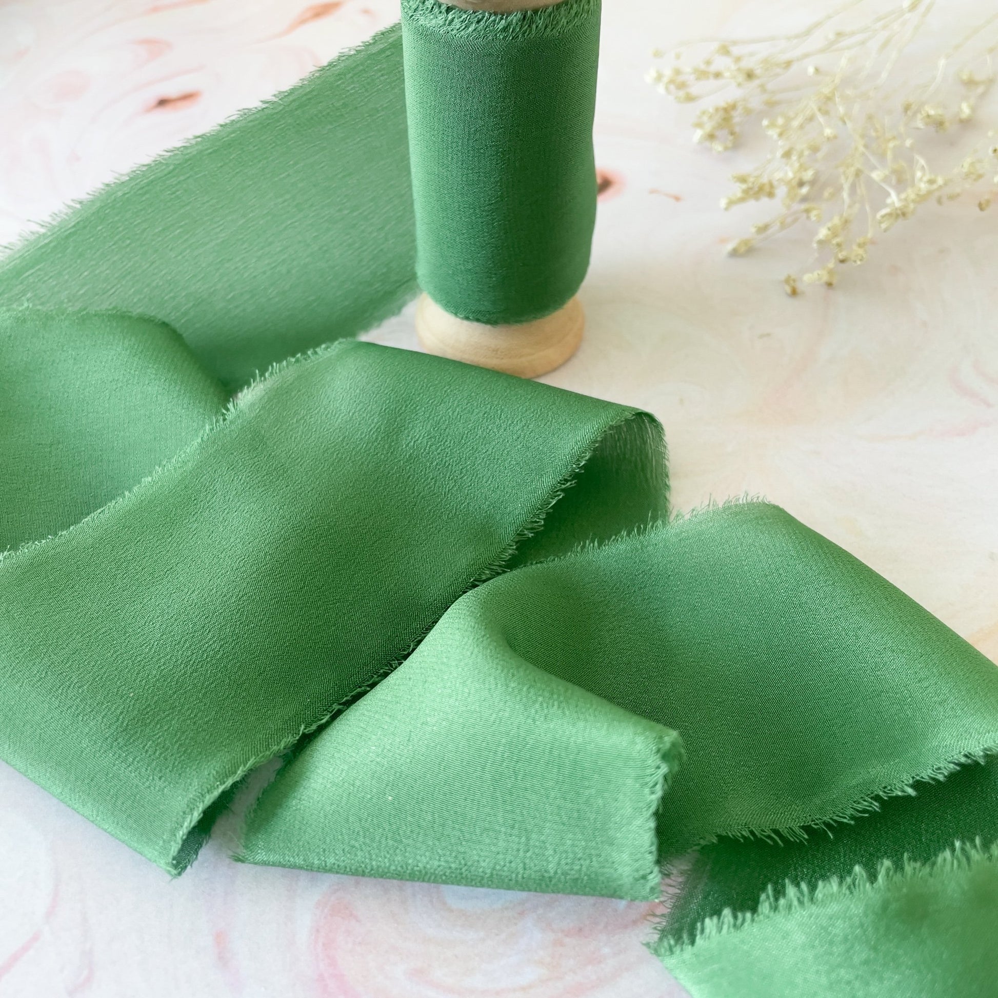 Green silk ribbon for crafts.  Luxury ribbon on a wooden reel.  By The Natural Paper Company.