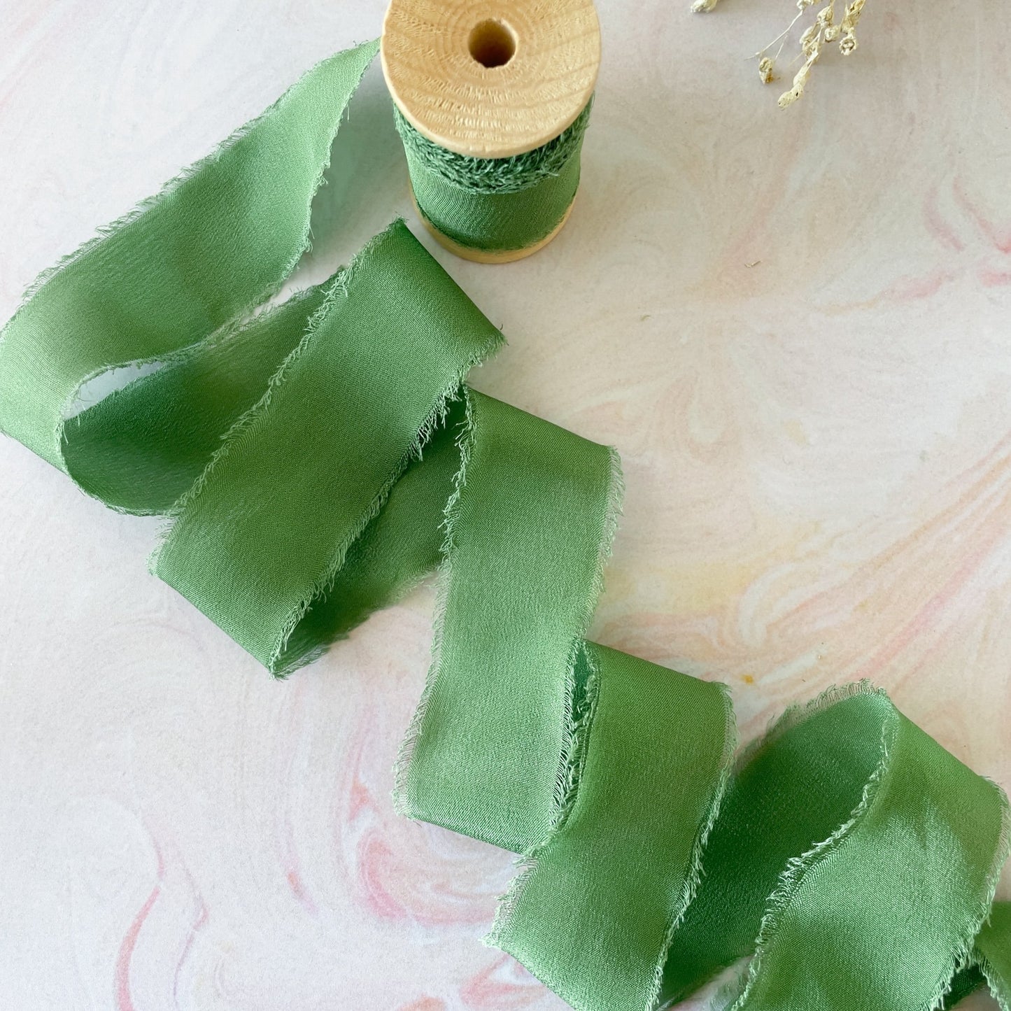 Silk ribbon in emerald green.  Luxury ribbon for decorating wedding invitations and stationery.  By The Natural Paper Company.