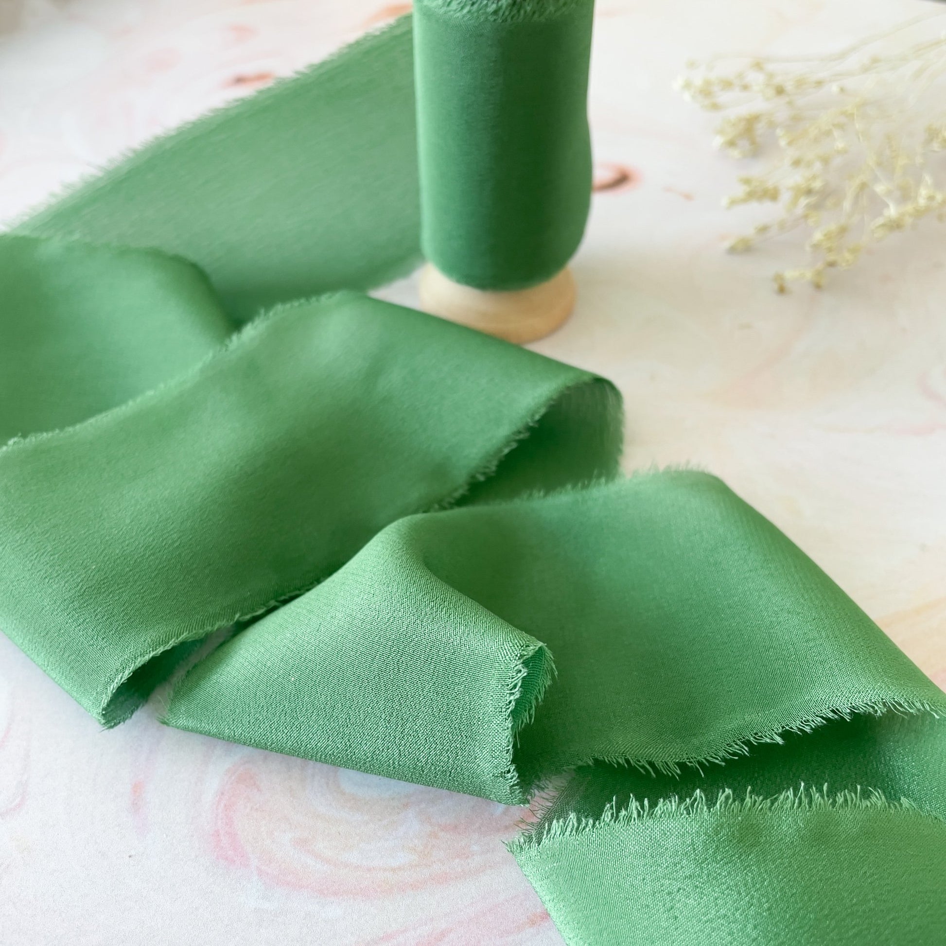 Green silk ribbon for crafts.  Fine silk ribbon with a raw edge.  By The Natural Paper Company.