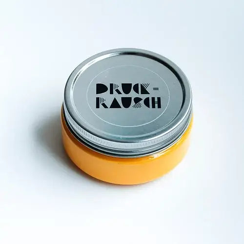 small jar of golden yellow water based ink for block printing