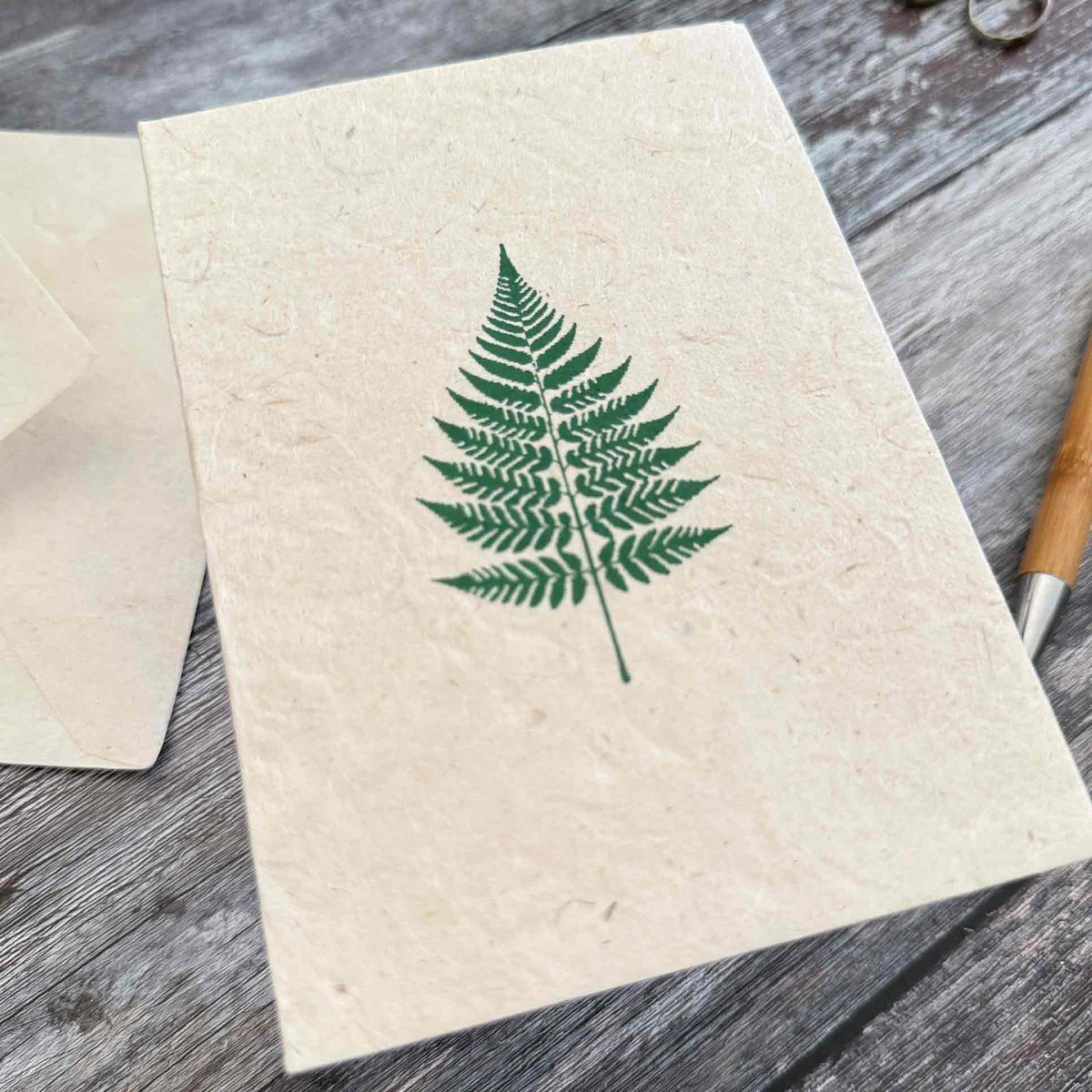 Handmade botanical notecards with green fern design on natural Lokta paper