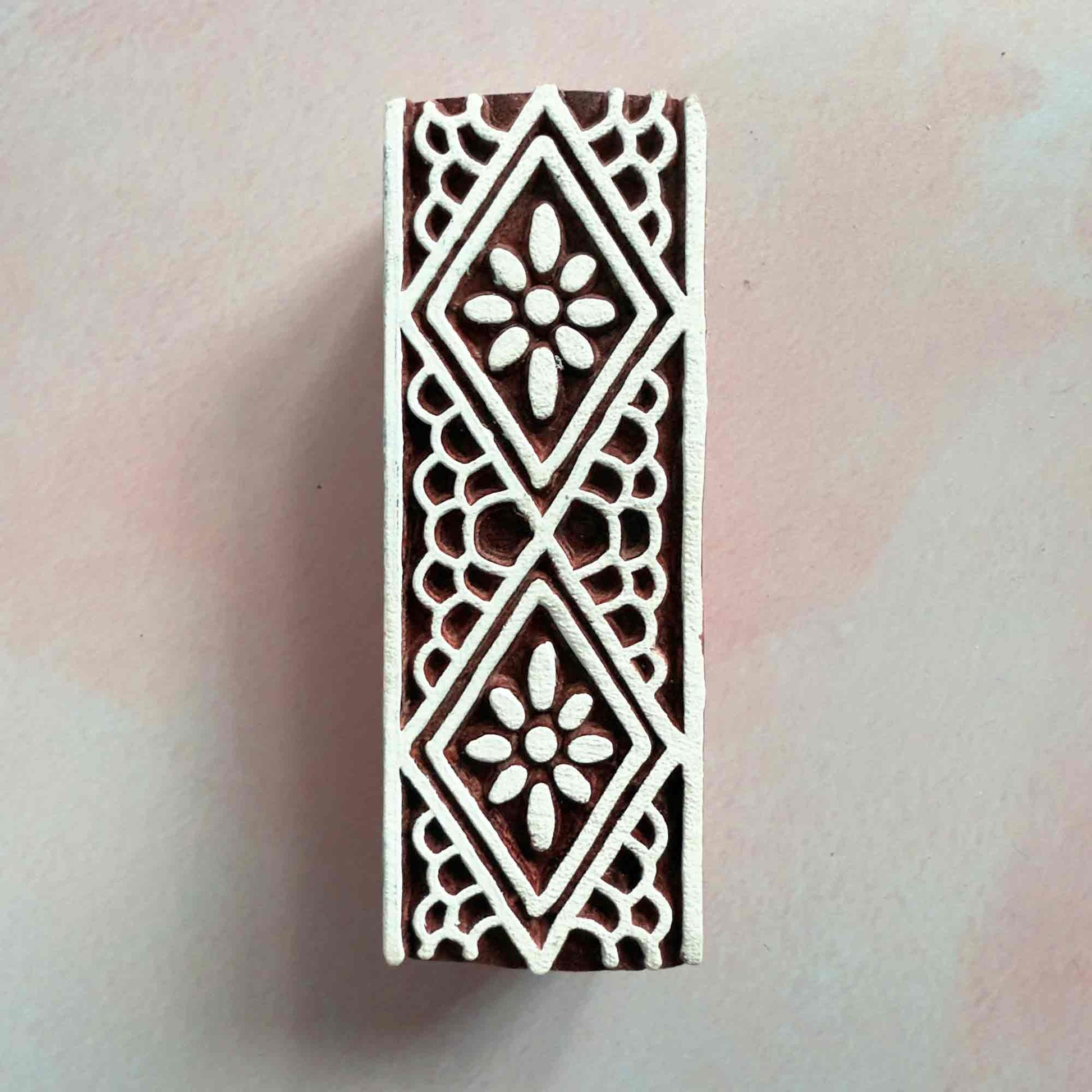 wood block stamp with a lace border pattern.  