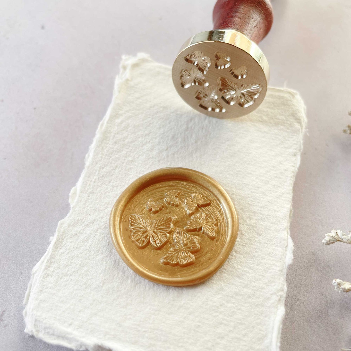 Sealing wax stamp with butterflies.  Make butterfly theme wax seals to decorate envelopes, stationery and packaging.  by The Natural Paper Company