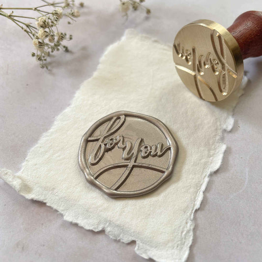 For you sealing wax stamp.  A calligraphy style wax seal for adding a personal touch to your correspondence, gift wrapping and more.  A large sealing wax stamp by The Natural Paper Company