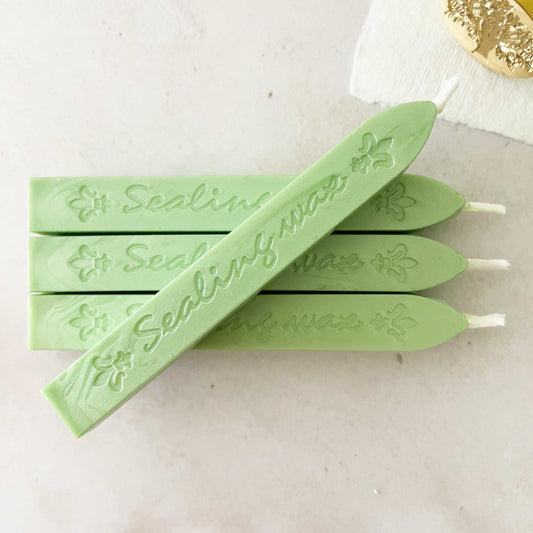 fresh green sealing wax sticks for making wax seals and stamps.  Sealing wax in pearlised green