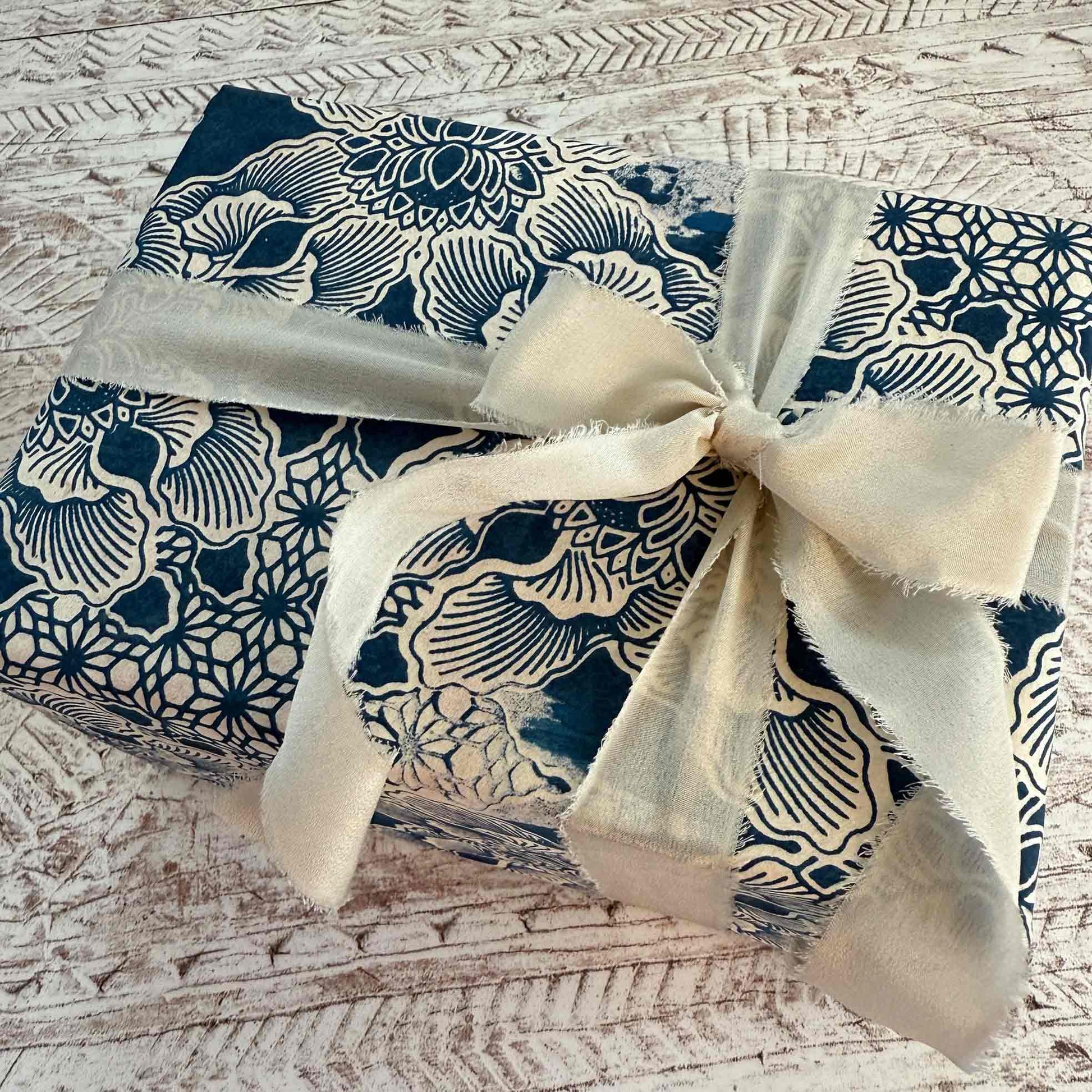 gift wrapped in handmade lokta wrapping paper in with navy blue and ivory flower pattern