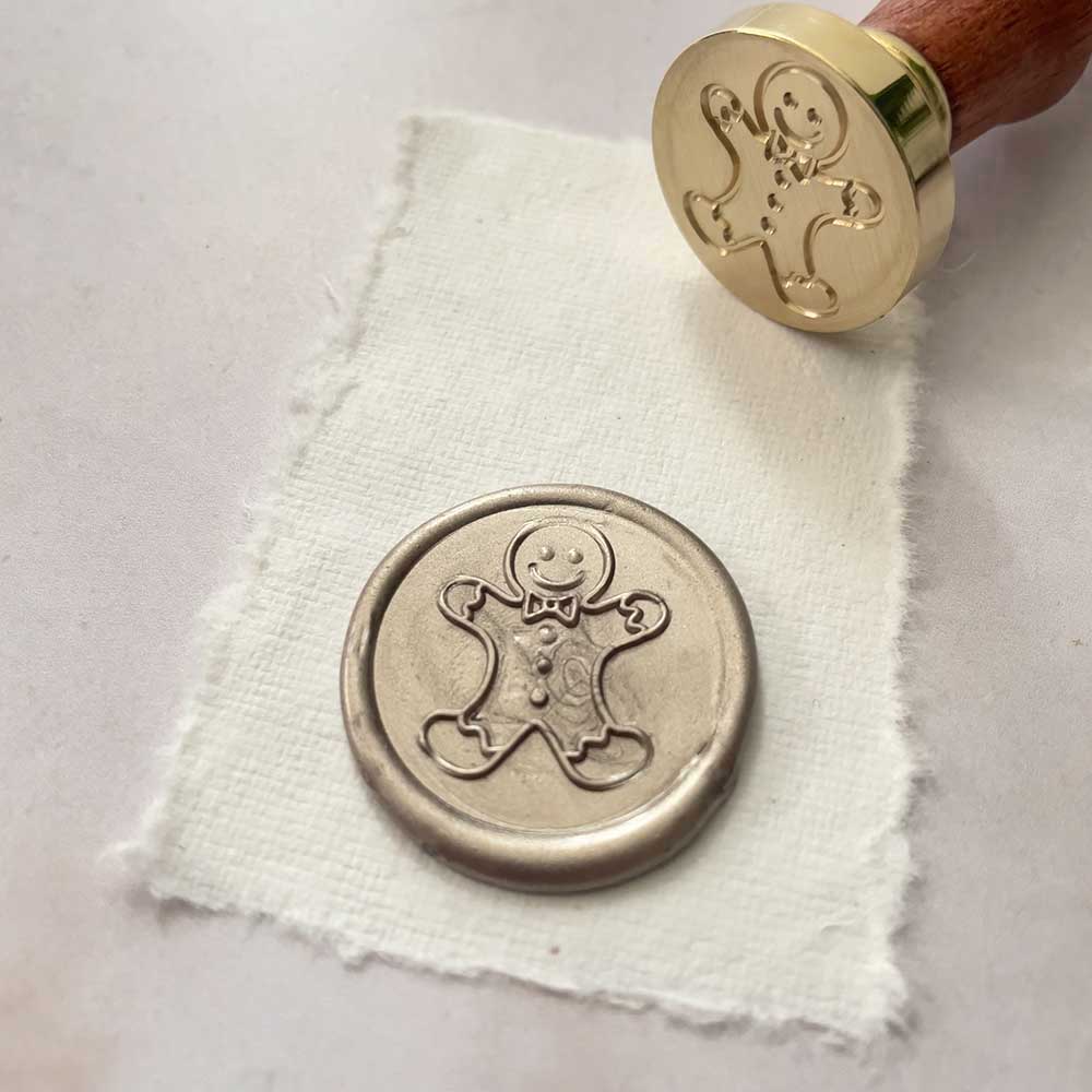 Seasonal theme wax stamp with a Gingerbread man design.  Cute sealing wax stamp with a brass head and wooden handle.  By The Natural Paper Company