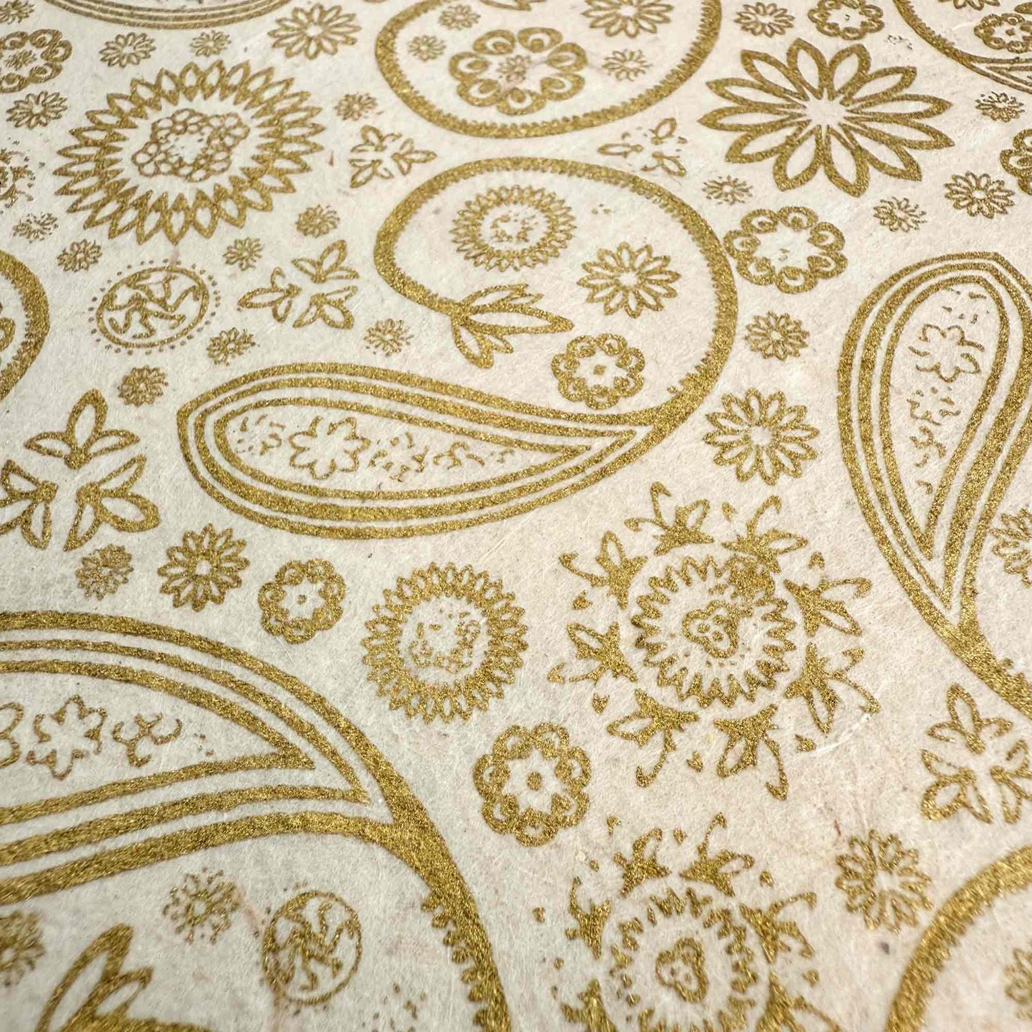 eco friendly gift wrap made from lokta paper with a gold paisley pattern