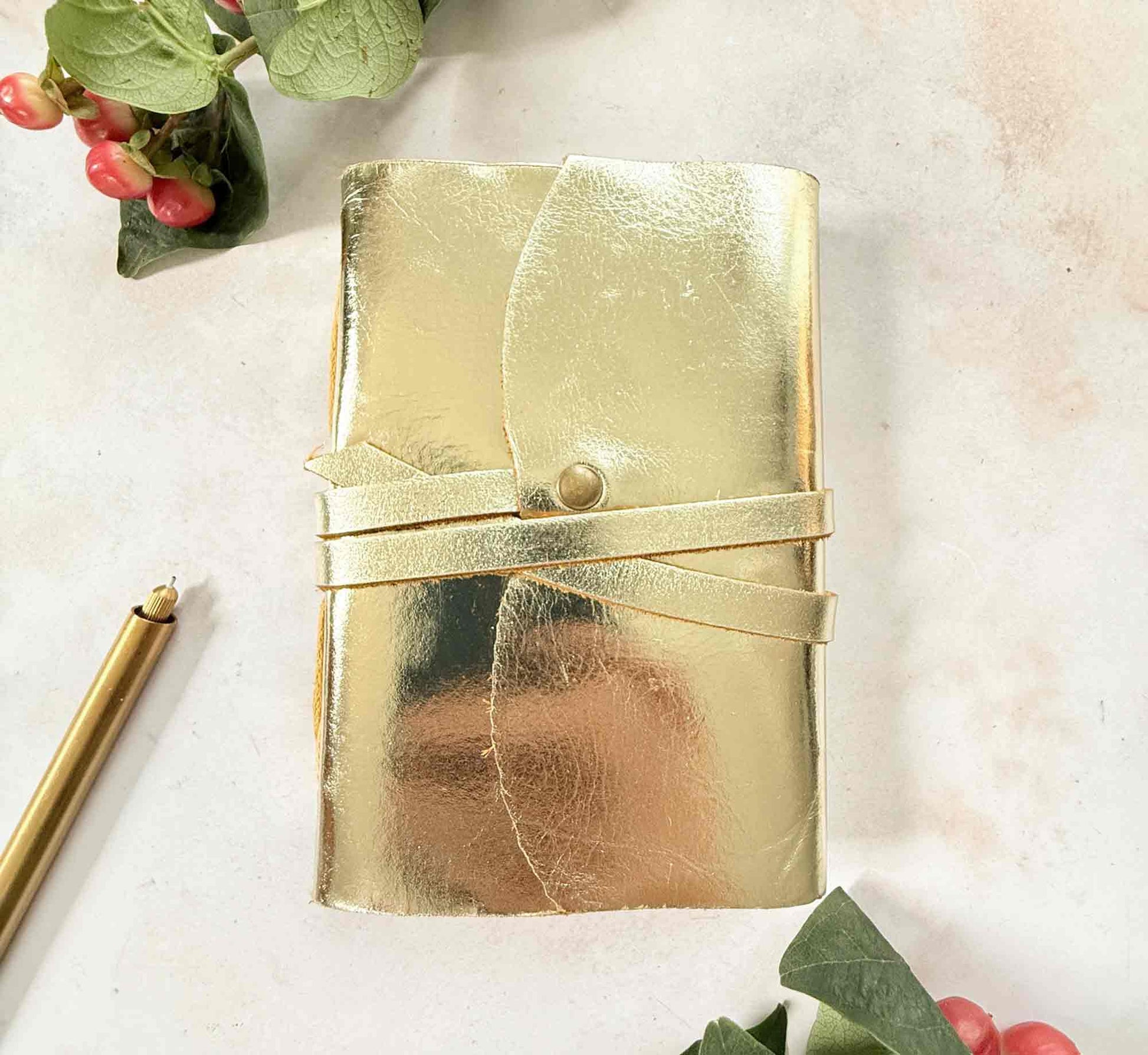 small gold leather notebook with tie