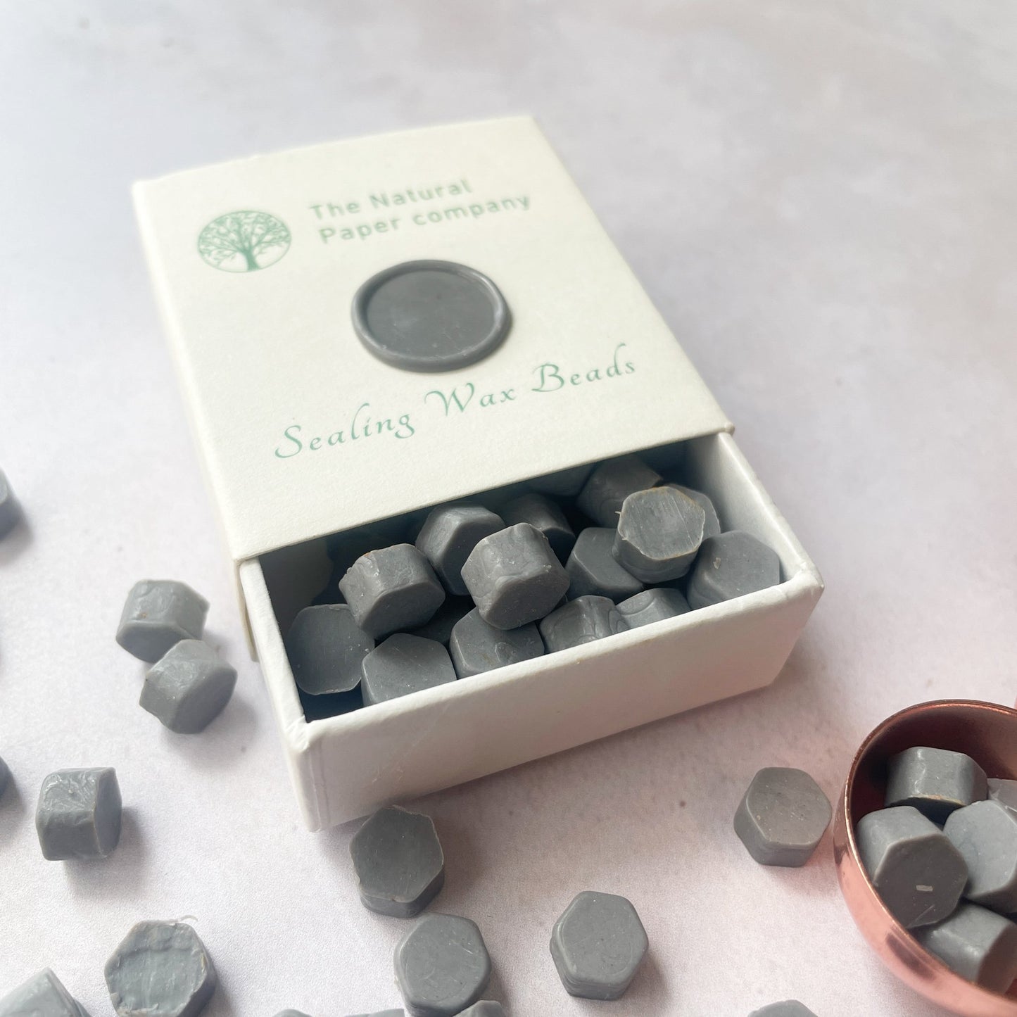 Box of sealing wax beads in graphite grey.  Eco friendly wax to make wax seals.  Plastic free, paraffin free and biodegradable.  By The Natural paper Company