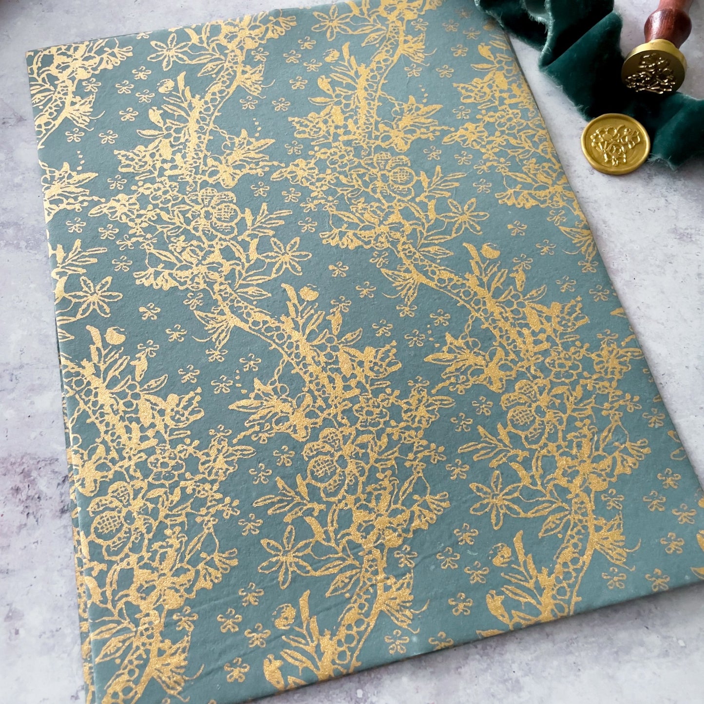 Eco friendly decorative paper for crafts.  Grey and gold patterned paper made from recycled materials.  By The Natural Paper Company.