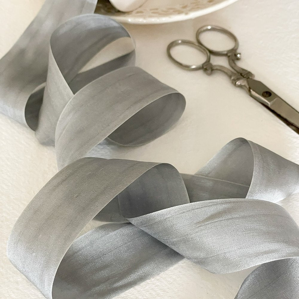 Fine silk ribbon for crafts.  Silver grey habotai silk ribbon with a closed edge.  Luxury ribbon sold by the meter.  By The Natural Paper Company