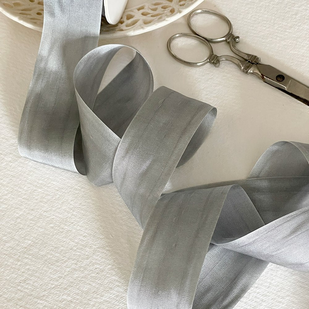 Silver grey silk ribbon with a closed edge.  Luxury habotai silk ribbon sold by the meter.  By The Natural Paper Company