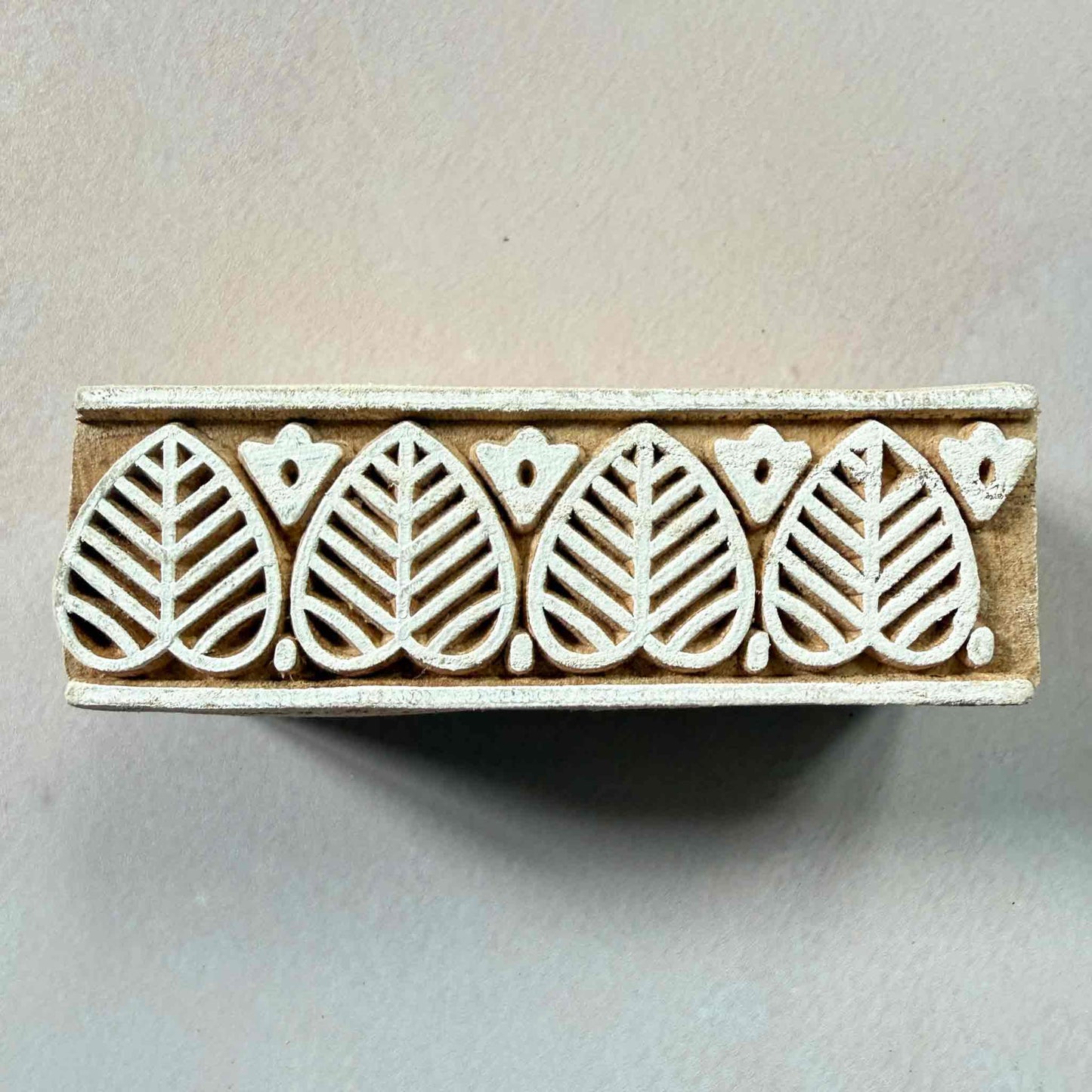 Wooden stamp with leaf pattern for creating borders