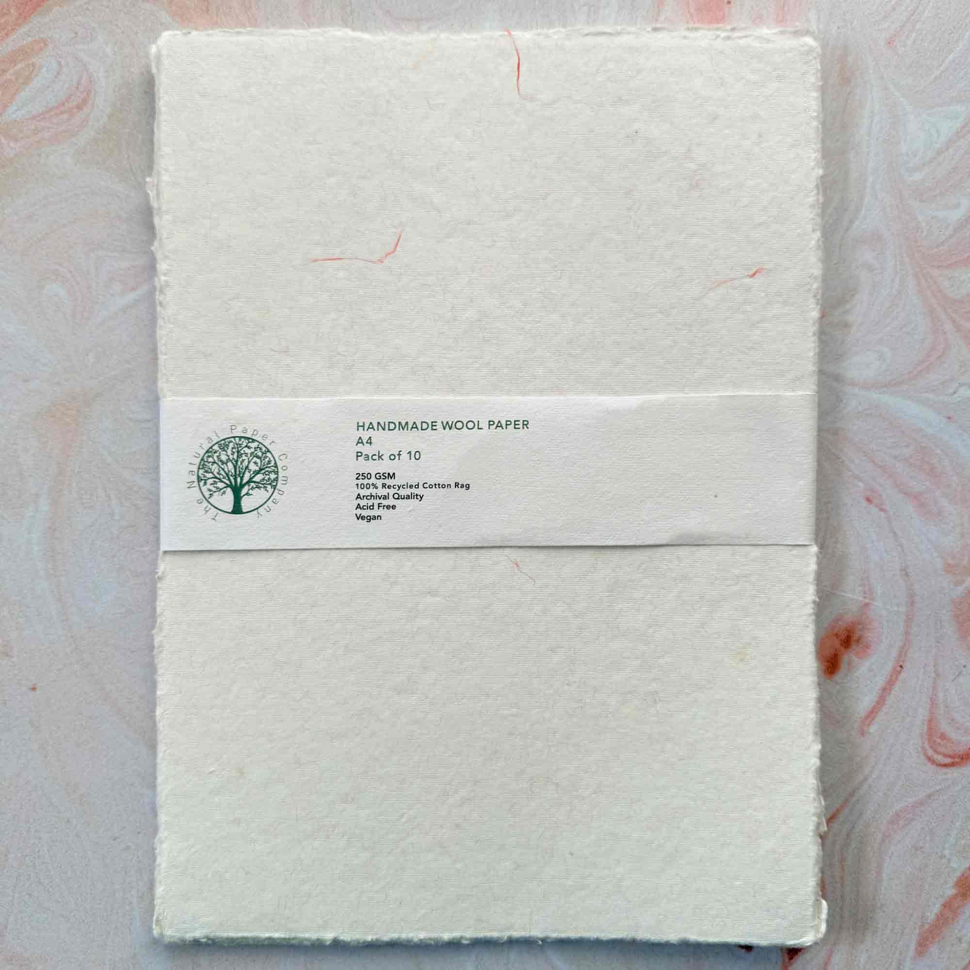 pack of handmade cotton paper with decorative wool fibres in pink and yellow