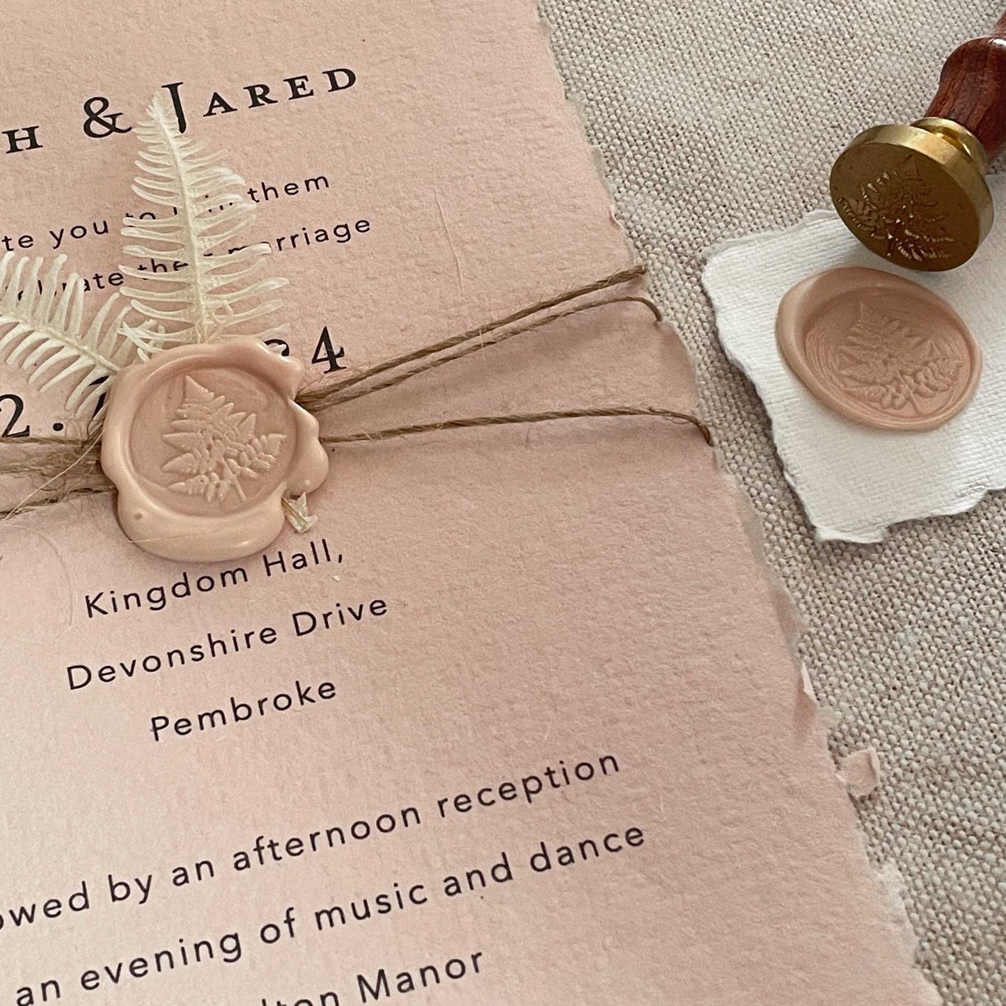 Blush pink eco friendly invitation made from handmade recycled paper with a fern leaf wax seal.  By The Natural Paper Company