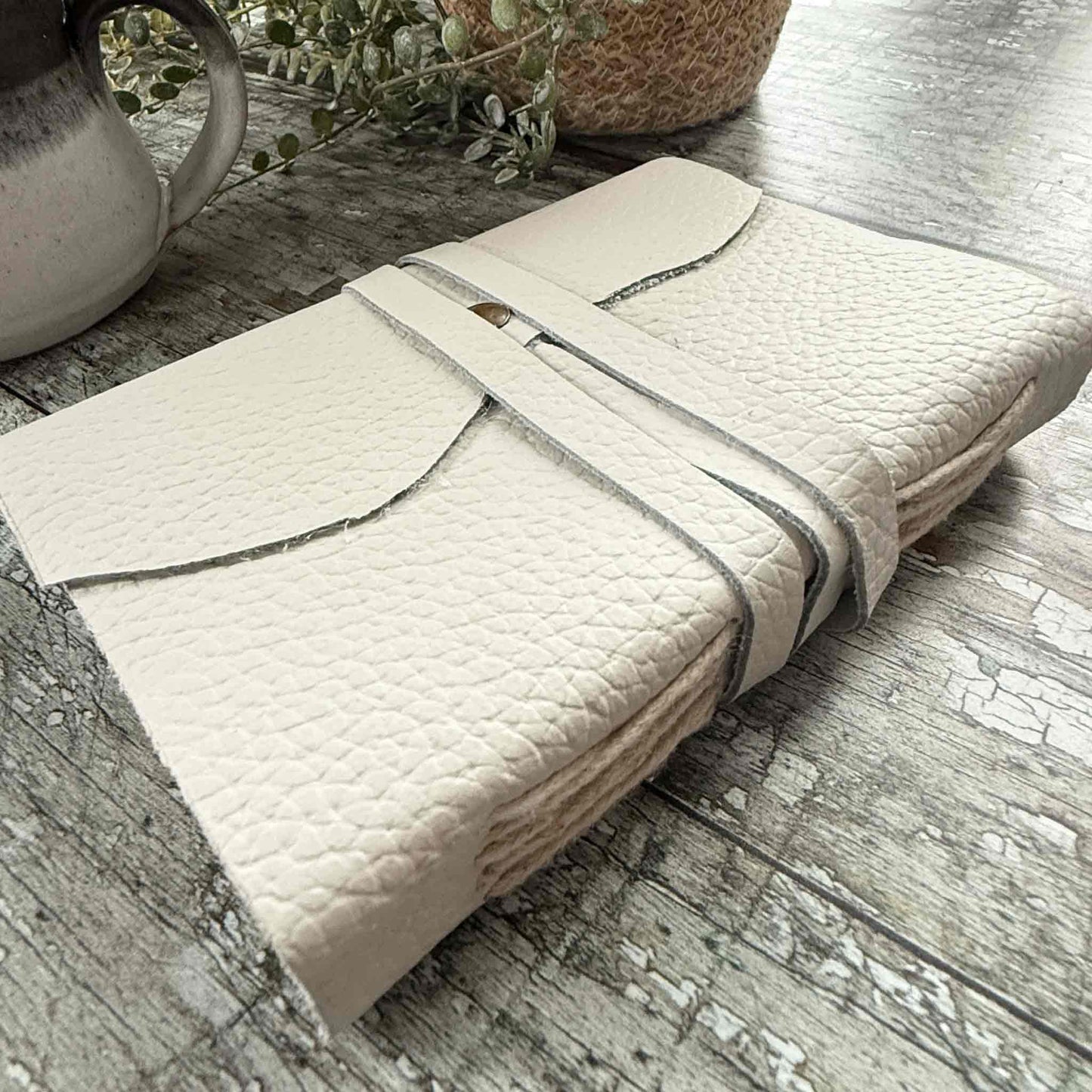small handmade leather notebook in ivory