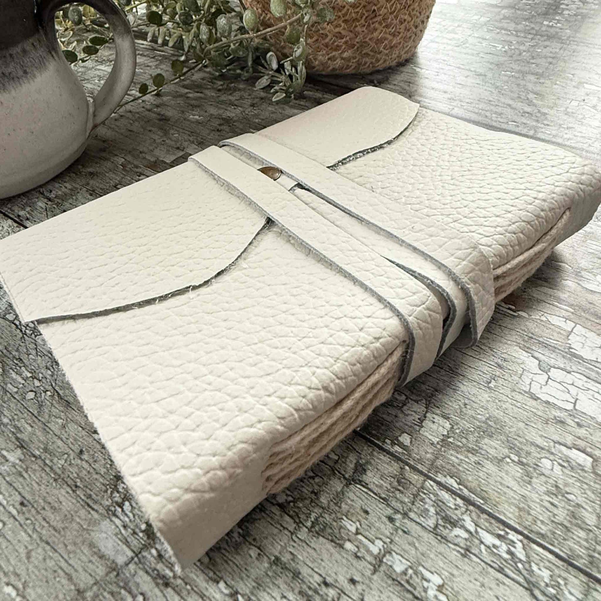 small handmade leather notebook in ivory