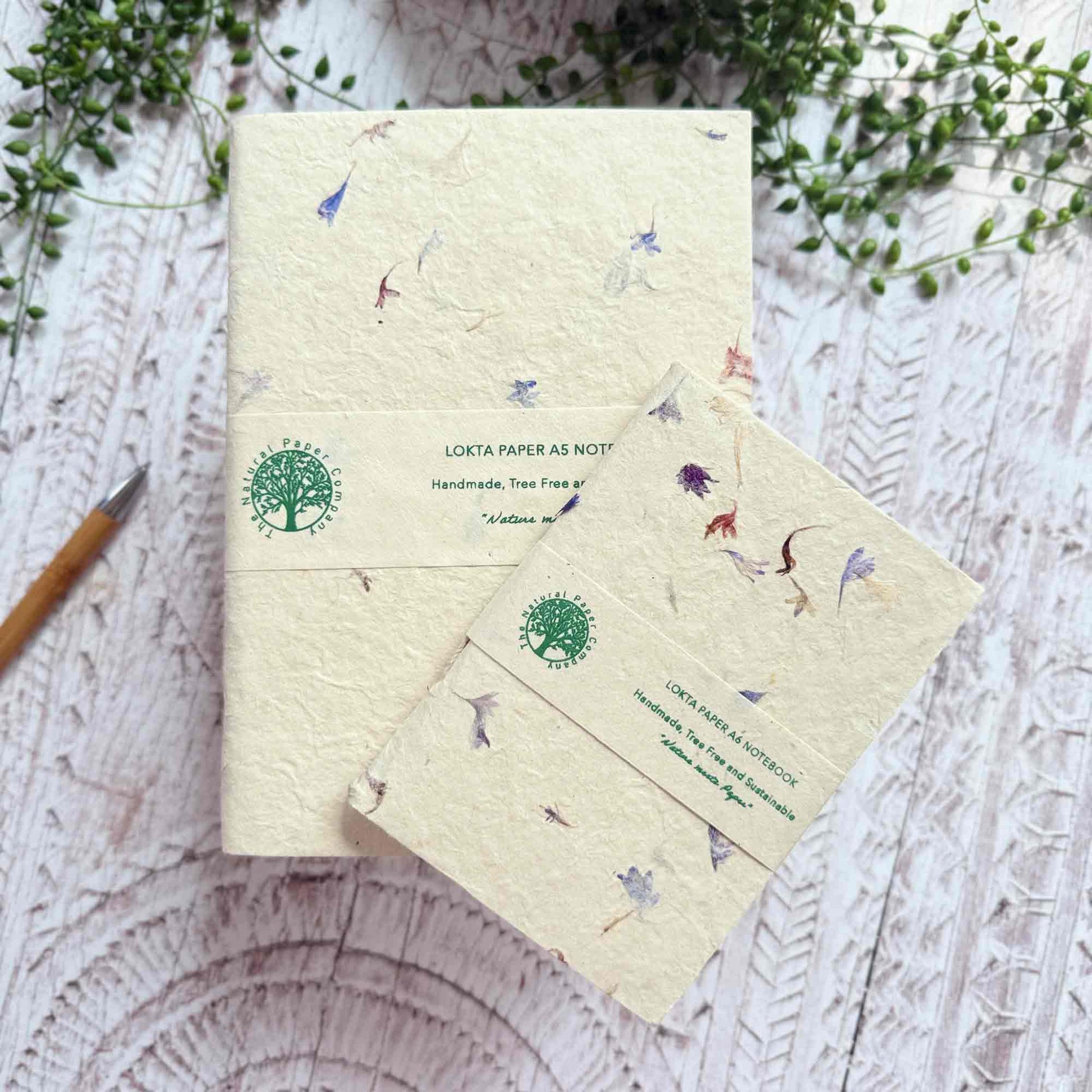 A5 and A6 Lokta notebooks showing The Natural Paper Company label, decorated with real Cornflower petals, handmade in Nepal