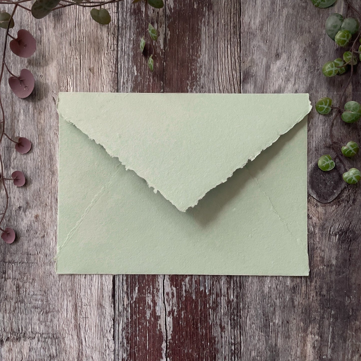 Handmade envelope with a deckled edge pointed flap.  Dusky green handmade paper envelope made from recycled cotton rag fibres.  By The Natural paper Company