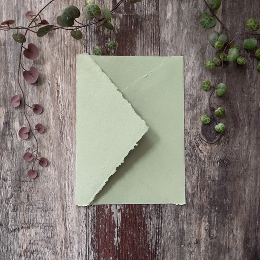 dusky sage green colour handmade paper envelope with pointed flap.  5" x 7" invitation envelopes with deckled edge