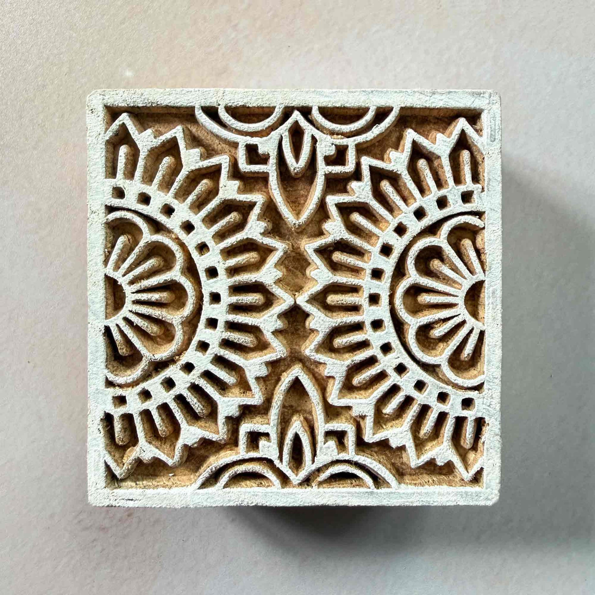 Wooden stamp block with intricate floral pattern for creating repeat prints