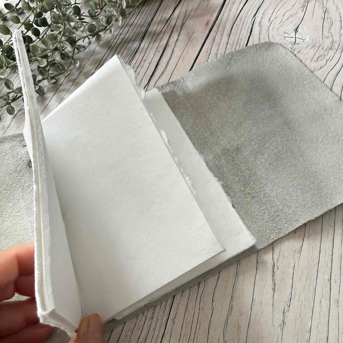 Ivory A6 leather journal open with removable handmade cotton paper inserts