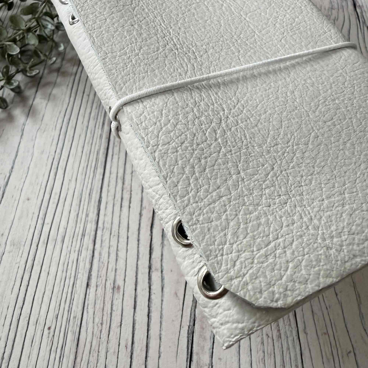 Ivory A6 refillable leather notebook showing textured leather cover and elastic closure