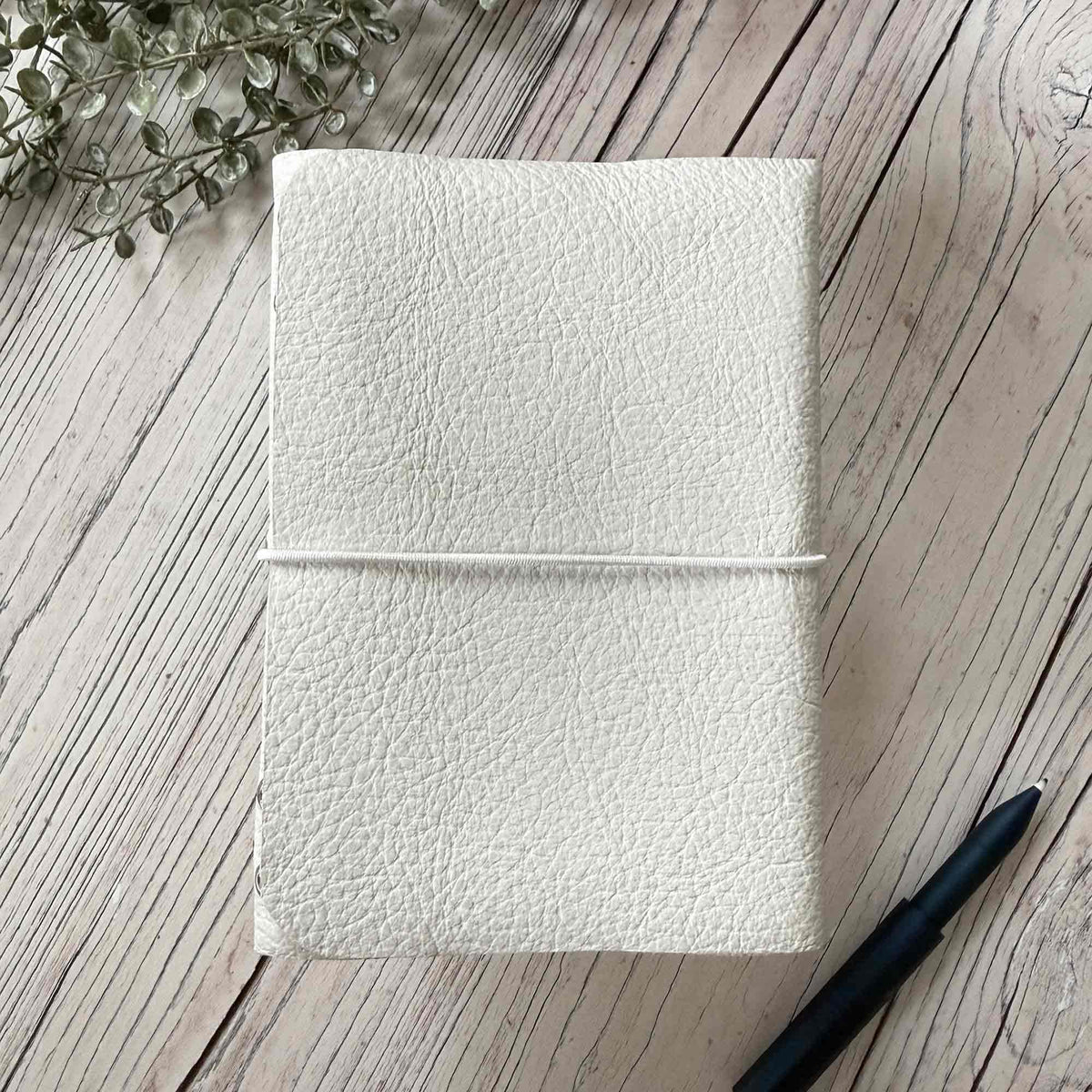 Handmade ivory A6 leather refillable journal with simple elastic closure