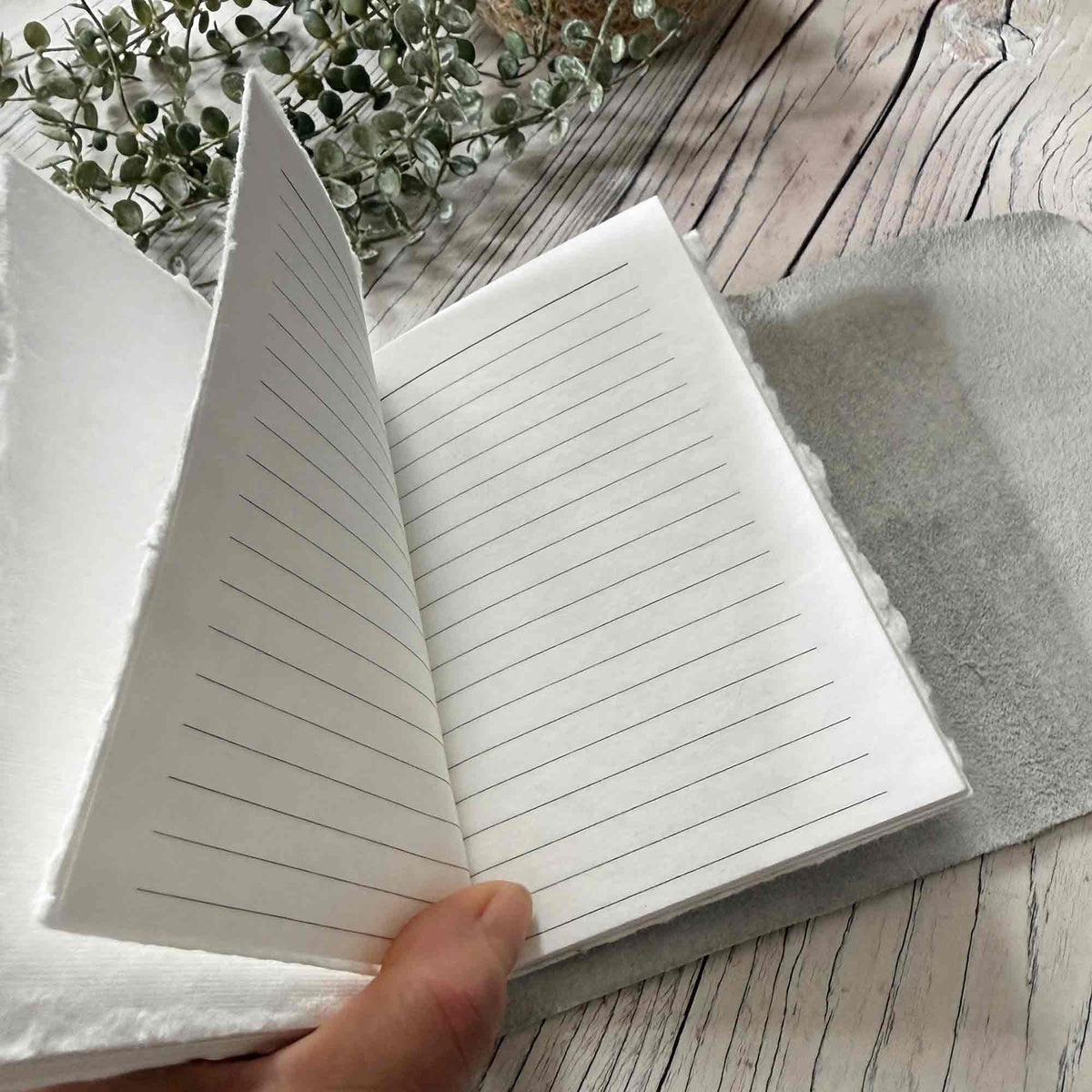 Ivory A6 refillable leather journal open to lined handmade cotton paper pages