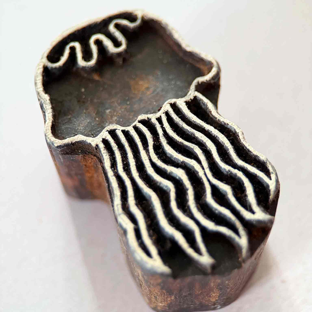 Jellyfish Indian wood block stamp shown from an angled close-up view