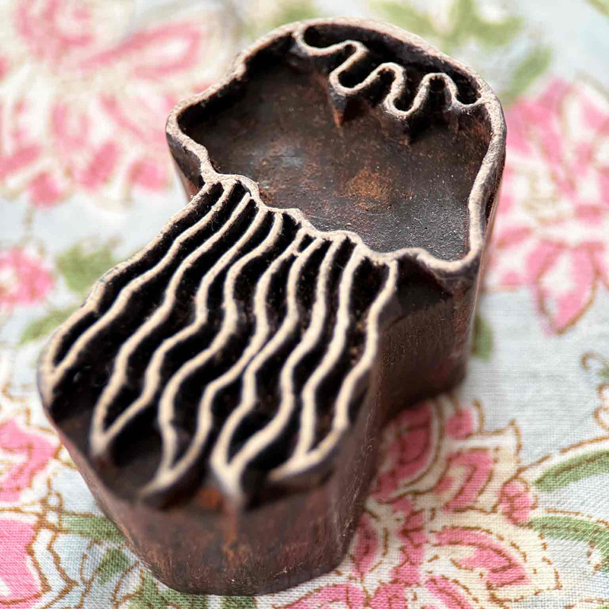Jellyfish wooden stamp displayed on block printed fabric with detailed flowing tentacles