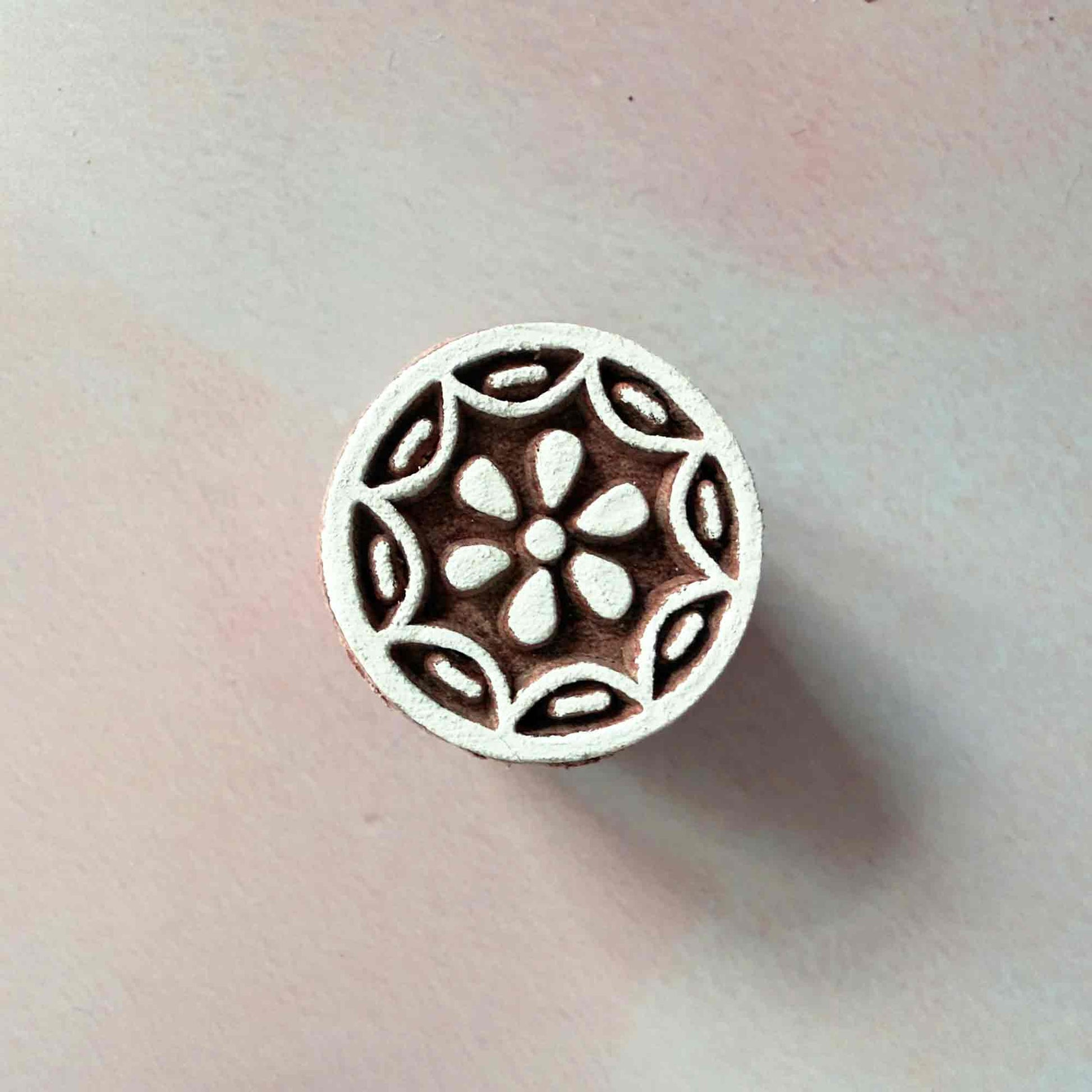 A small wood block stamp with a flower pattern.  Hand made stamp for decorating cards, gift wrapping, fabric and more
