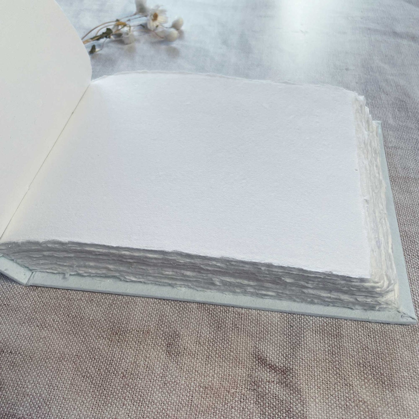 Blank guest book with a light blue cover.  Blank journal to decorate yourself.  Made from handmade recycled cotton rag paper with a deckled edge.  by The Natural Paper Company