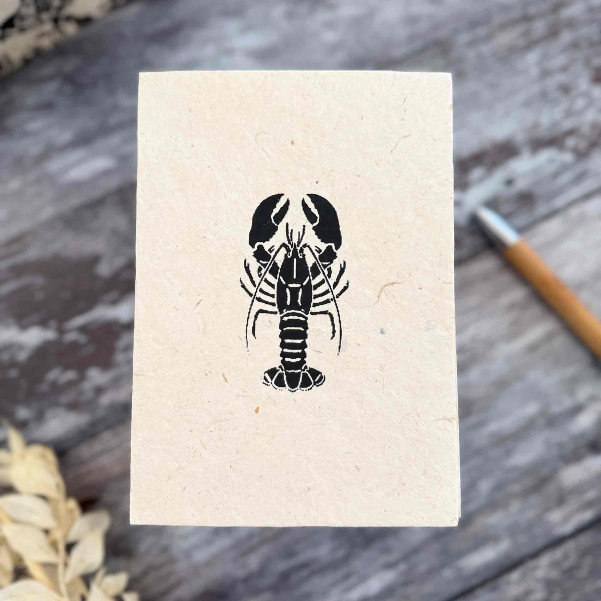 A6 lobster greeting card with black screen printed design on natural handmade Lokta paper