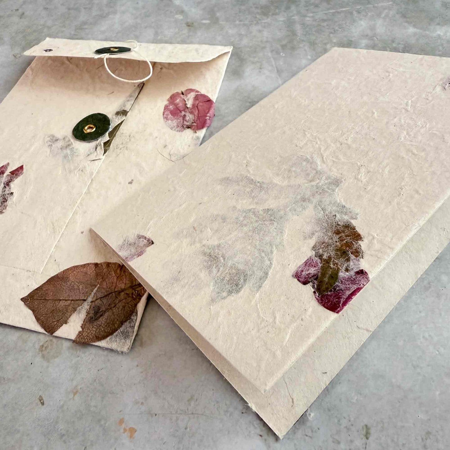 washer and string envelope with folded card made from lokta paper with dried pressed flowers