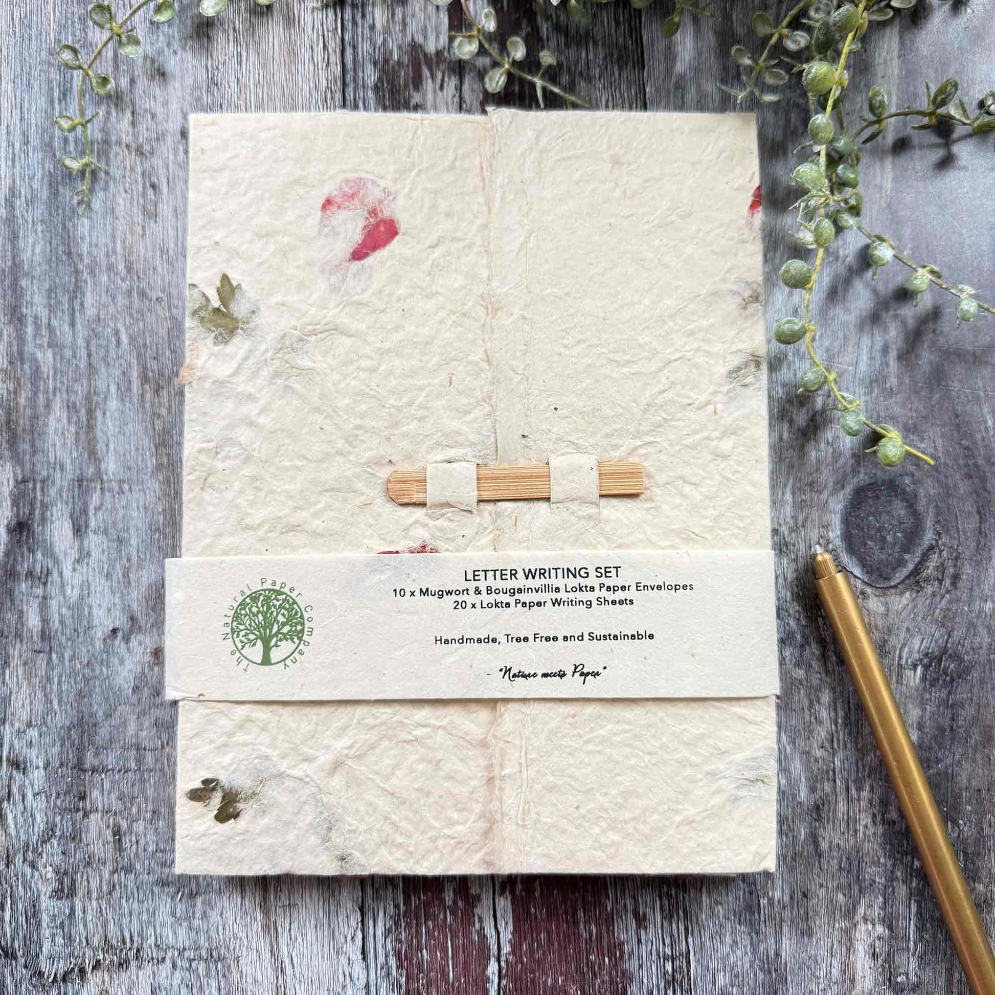Closed Lokta paper letter writing set folder with botanical inclusions, bamboo fastener, branded band, tree-free sustainable stationery, The Natural Paper Company