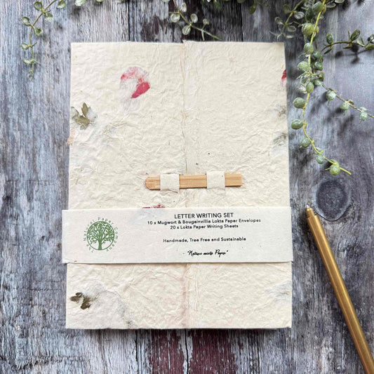 Closed Lokta paper letter writing set folder with botanical inclusions, bamboo fastener, branded band, tree-free sustainable stationery, The Natural Paper Company