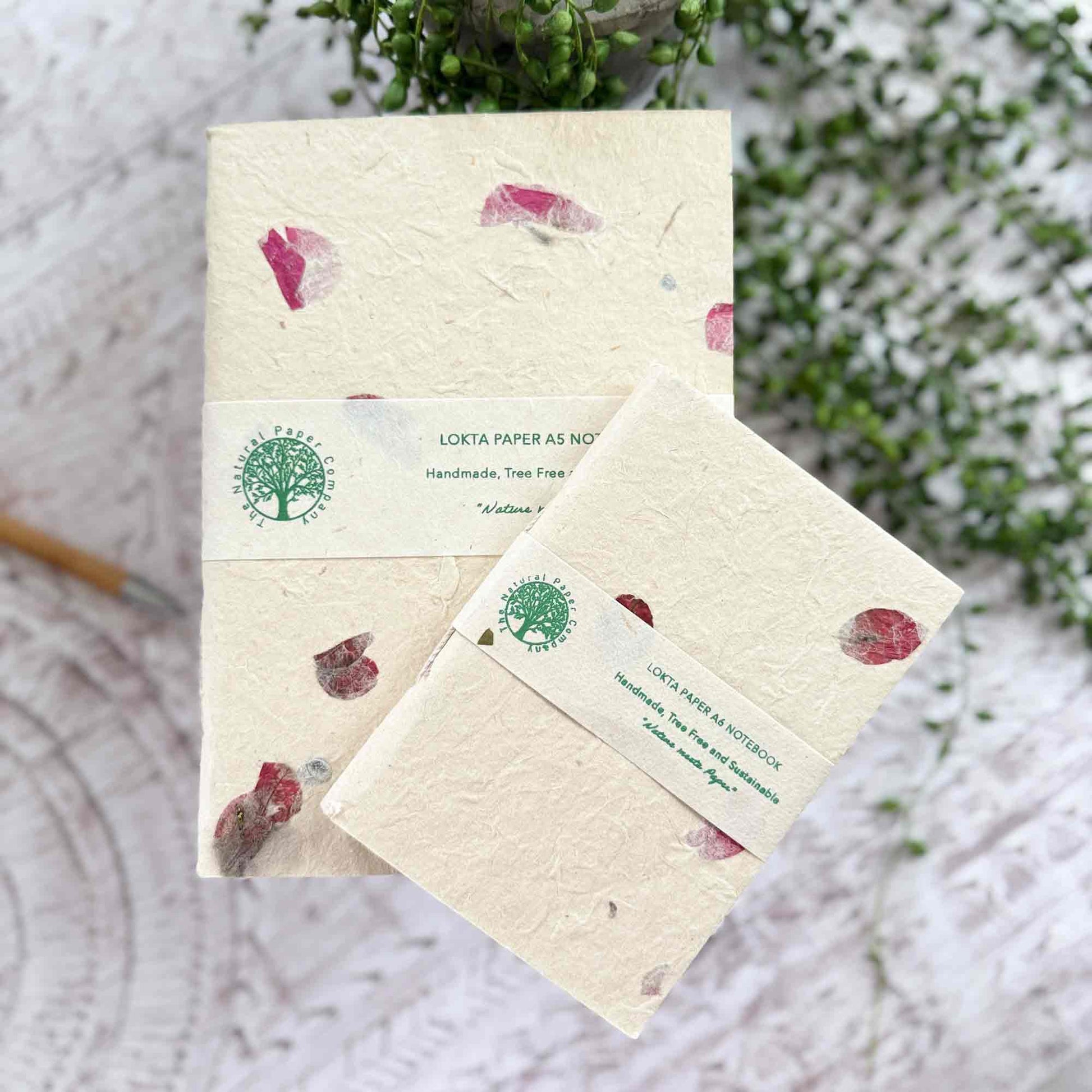 A5 and A6 Lokta notebooks showing The Natural Paper Company label, decorated with real Bougainvillea petals, handmade in Nepal