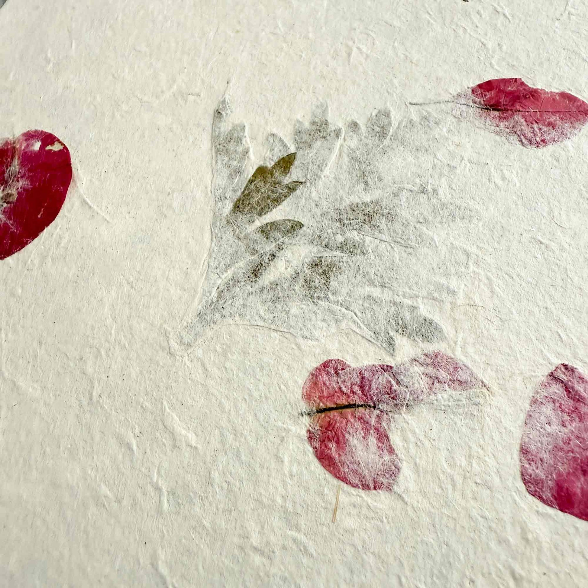 handmade lokta paper with dried mugwort leaves and bougainvillea petals
