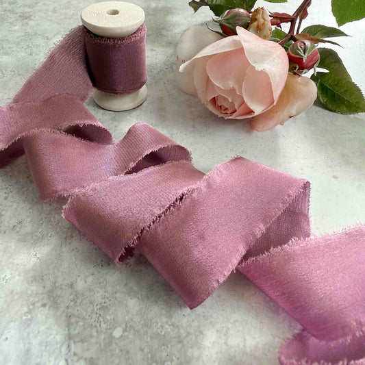 25mm wide silk ribbon with a frayed edge.  Mauve colour.   5 metre length on a wooden reel