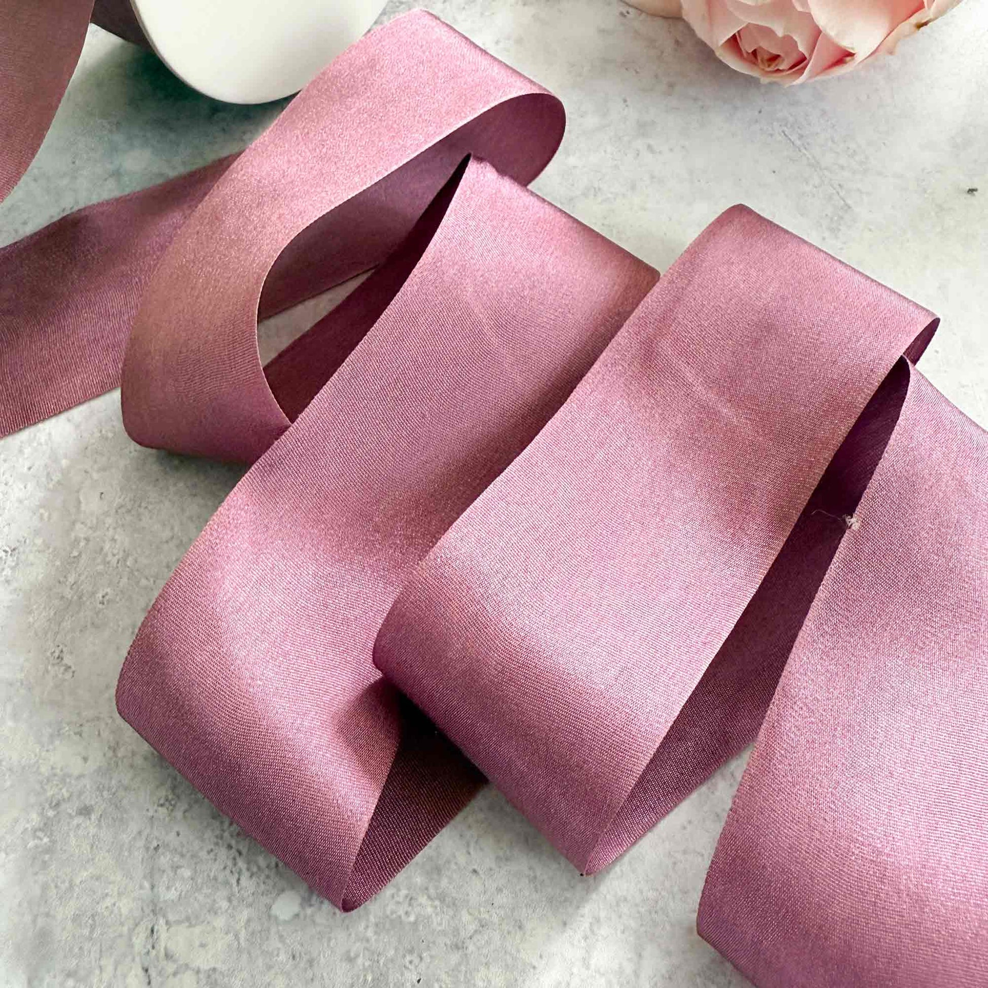 Mauve silk ribbon sold by the metre.  Fine silk ribbon with a closed edge