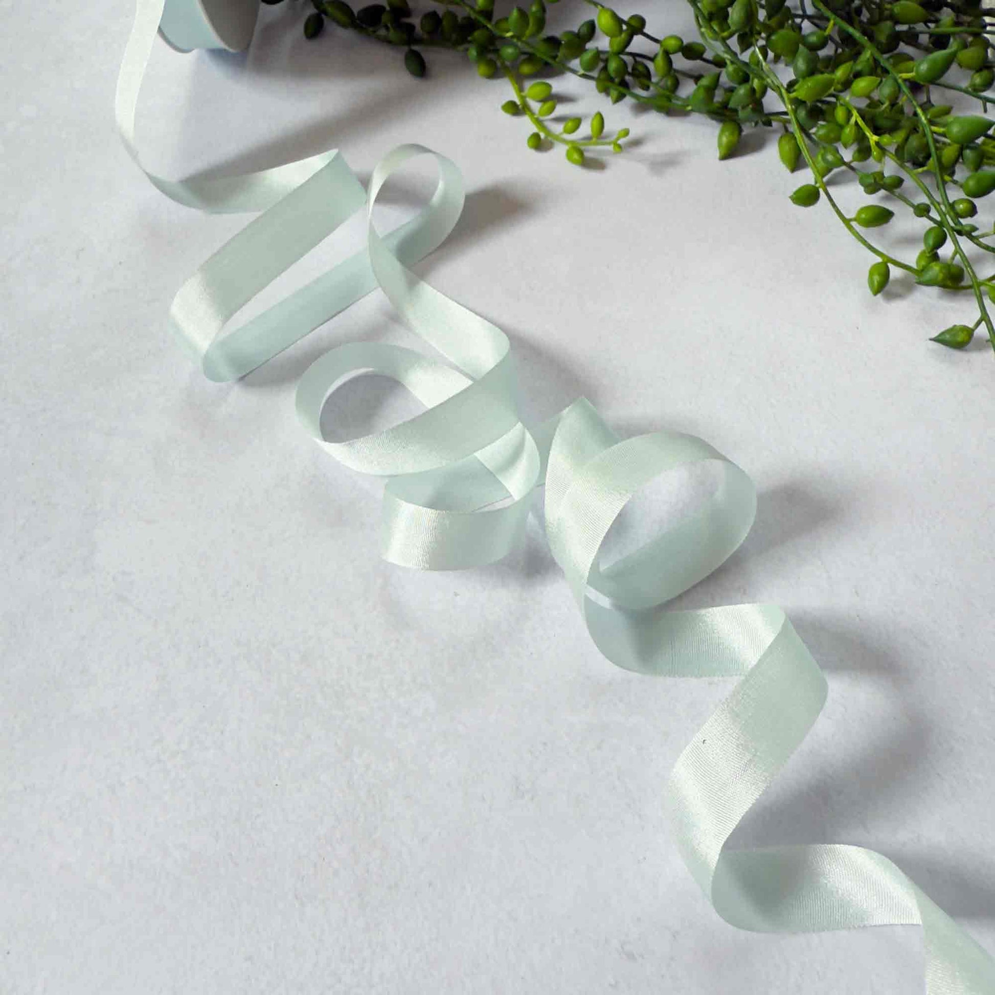 narrow silk ribbon in a pastel green colour
