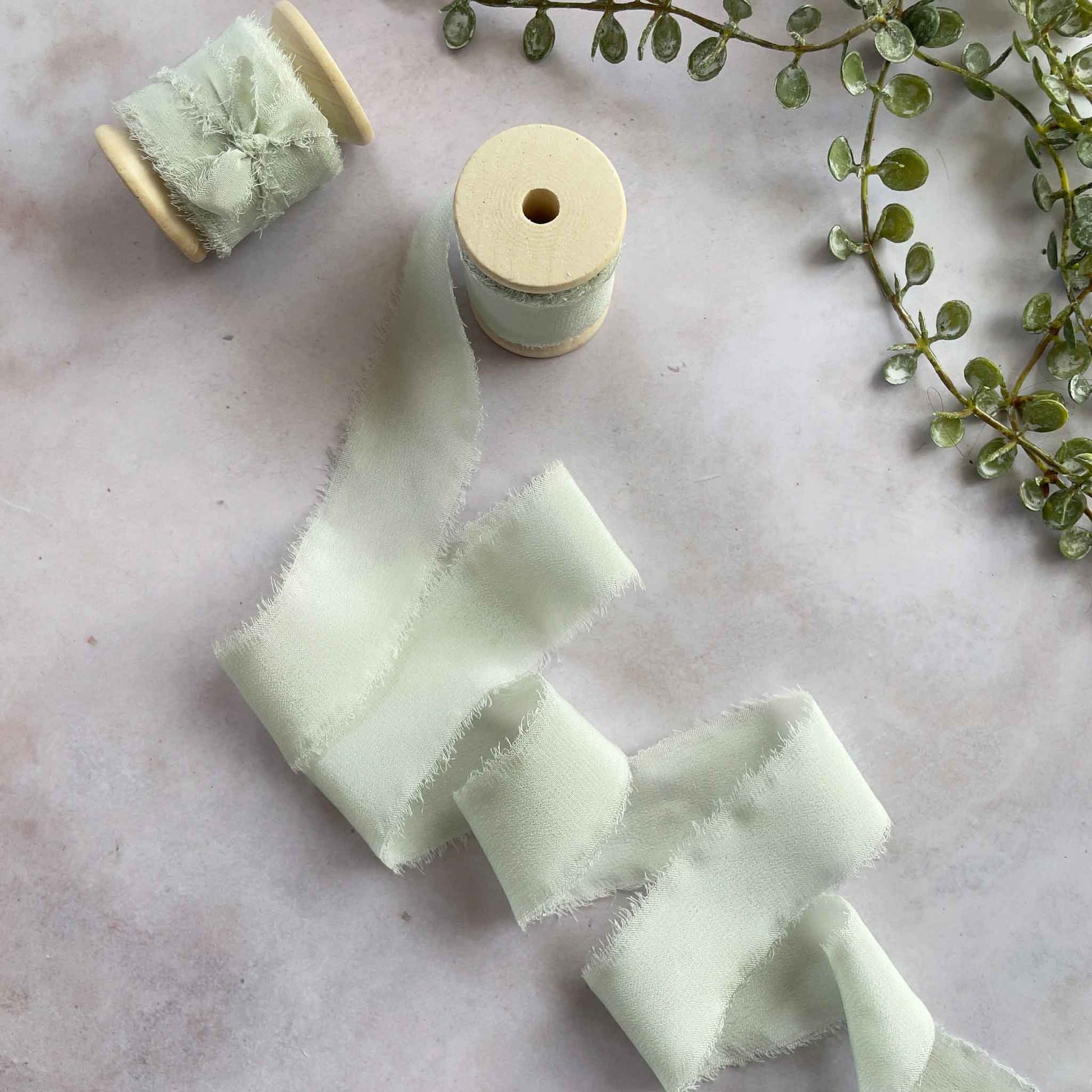 Pastel Green Silk Ribbon on a Wooden Reel