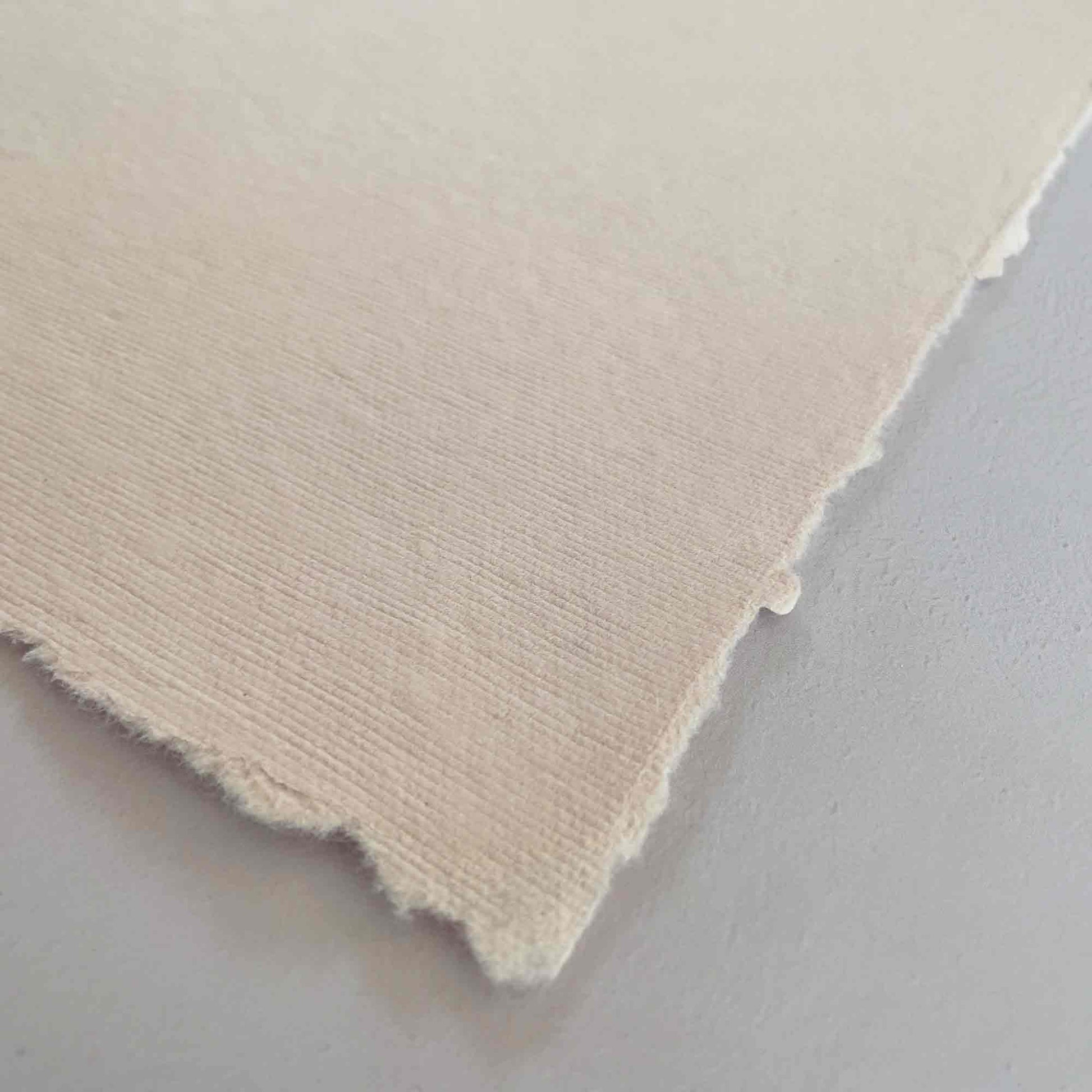 Handmade cotton rag paper with deckled edges,  soft blush pink colour paper