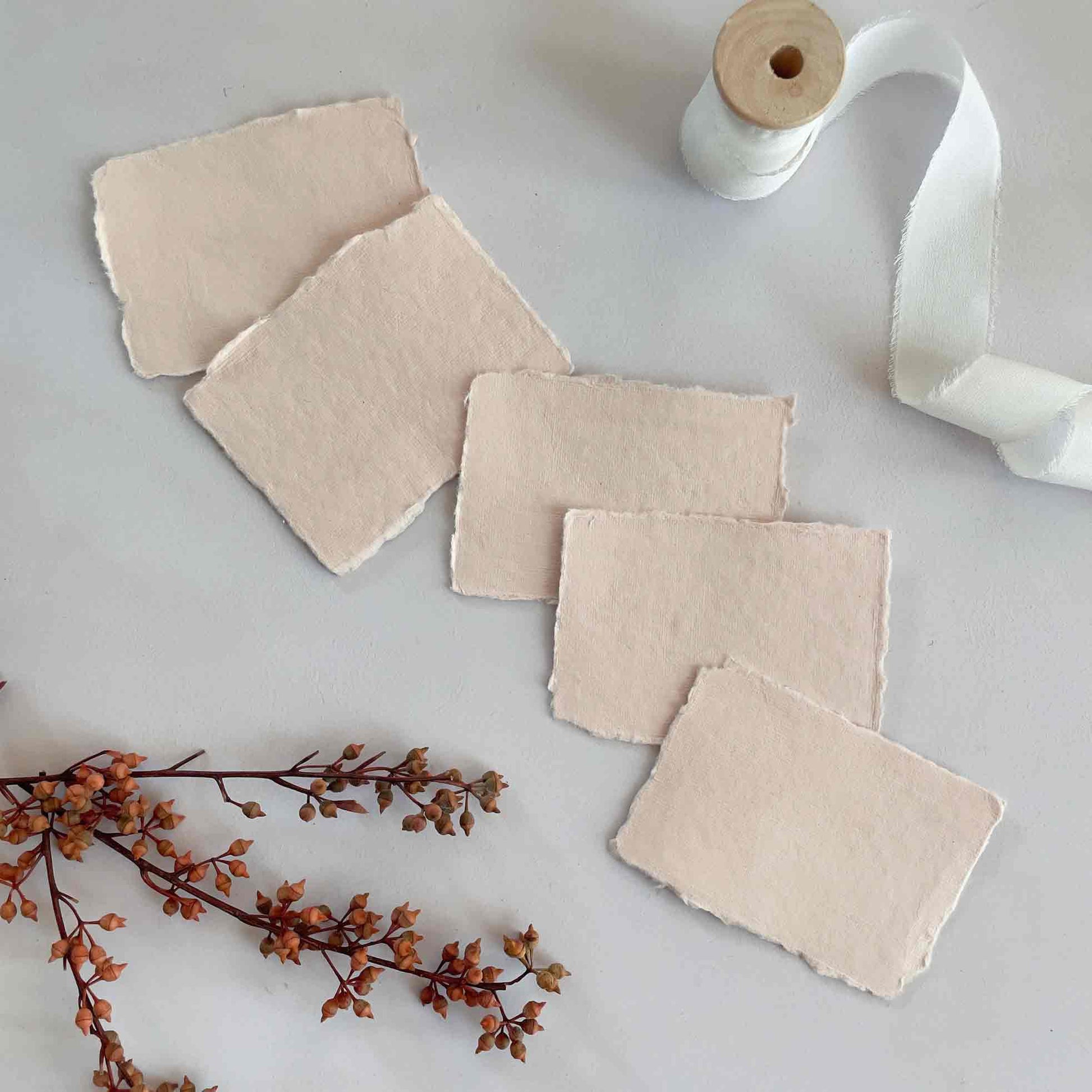 Small pieces of handmade cotton rag paper in blush pink.  Handmade Paper place cards by The Natural Paper Company